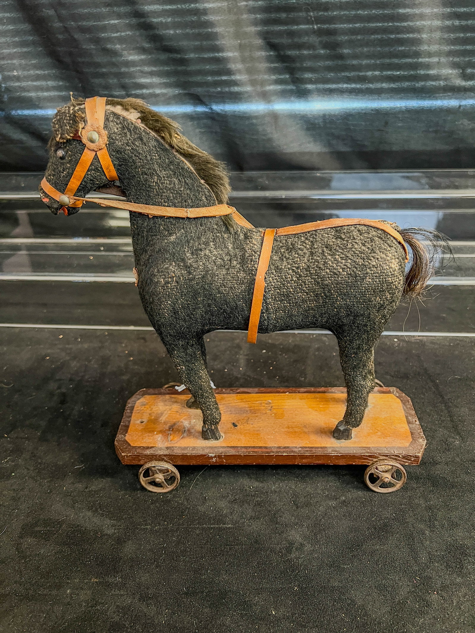 German Mohair Horse Pulltoy c.1890: This 1890's German horse pull toy has real leather reigns, wood base and feet, and mohair covered paper machier body. One wheel doesnt match the others, good, played with condition.