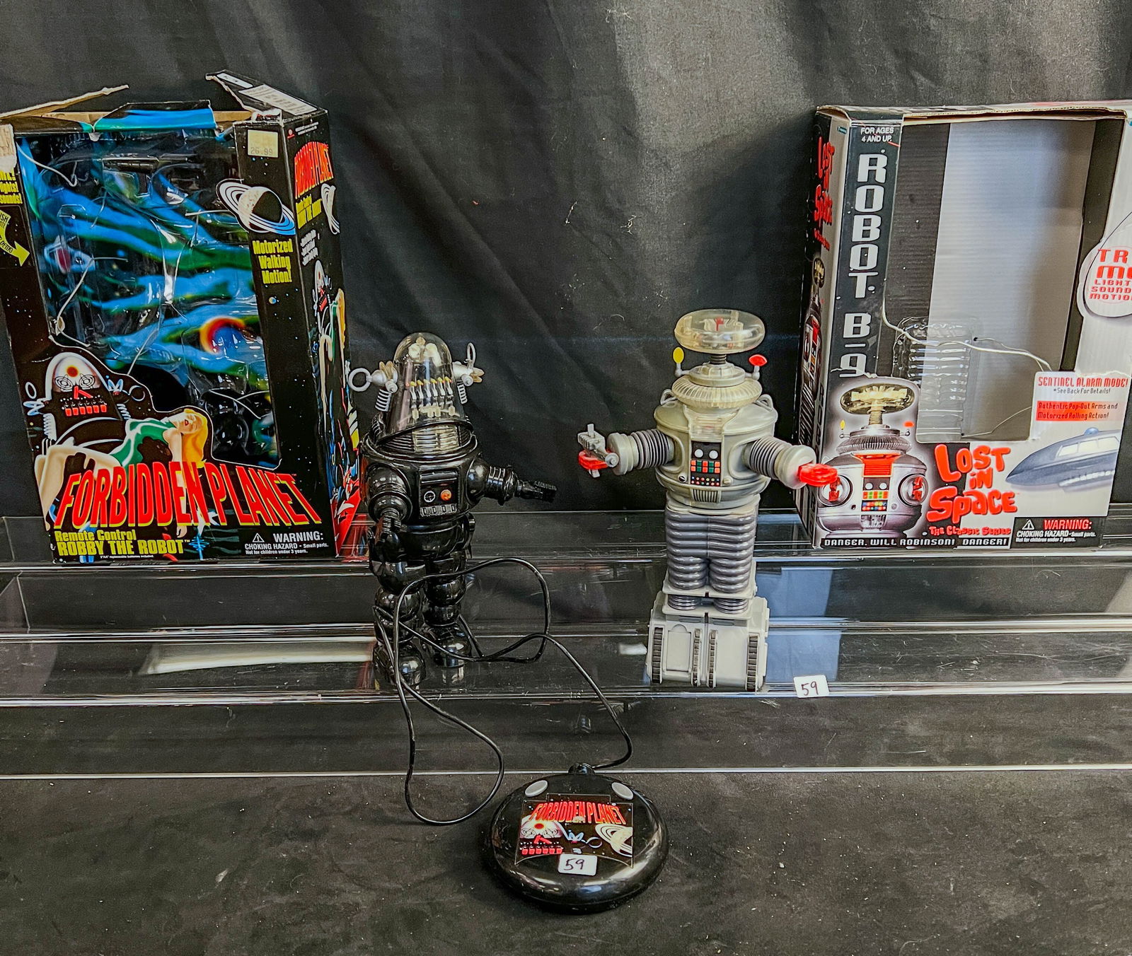 2 Trendmasters 1990's Movie Robots. Robot B9 - Lost in Space in Box , and Robbie the Robot- Both in: These two 1990's Trendmaster Movie based robots in their original boxes include a 11" tall Lost in Space Robot B9 in its box with push button lights, sound, and motion, motorized rolling action, Pop o