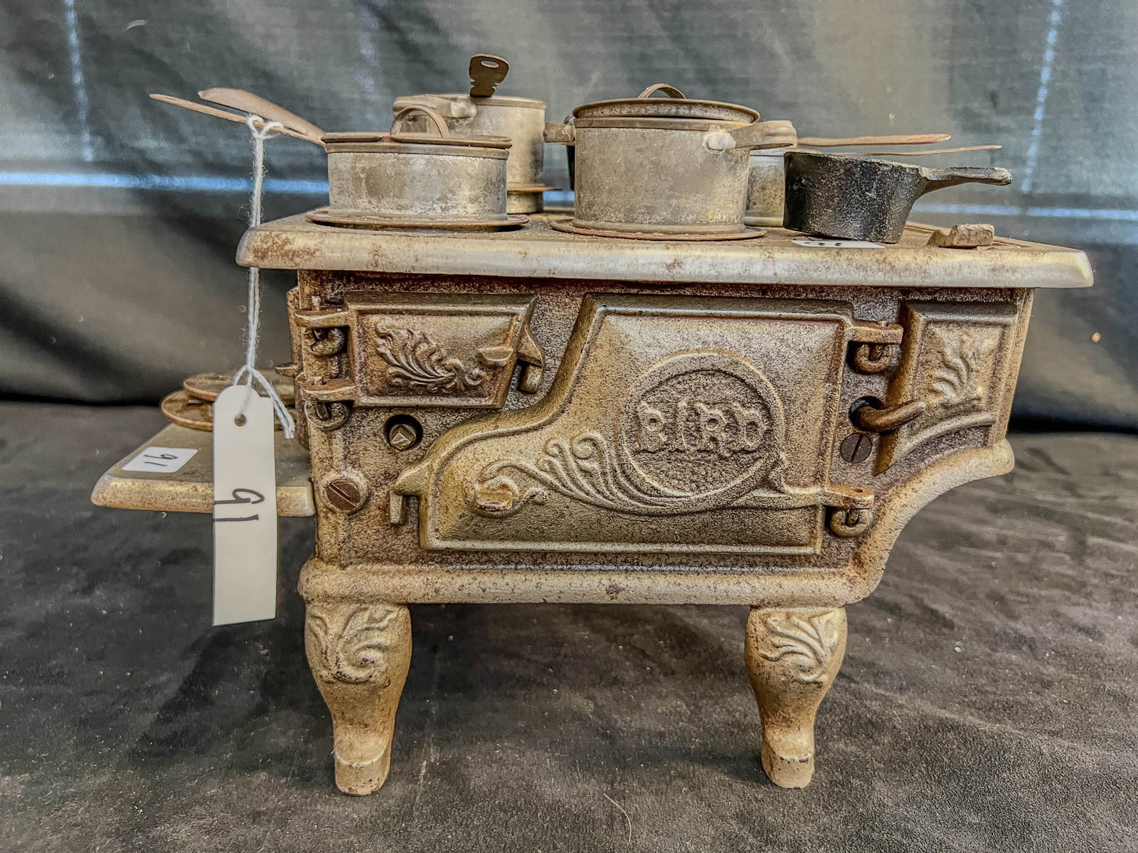 Victorian Bird Cast iron Doll Stove and Accessories: A Bird Victorian Cast cast iron Doll Stove and Accessories to include scroll decoration on legs, kettle, pots and pans, lids, burner covers and handles, working doors and more!