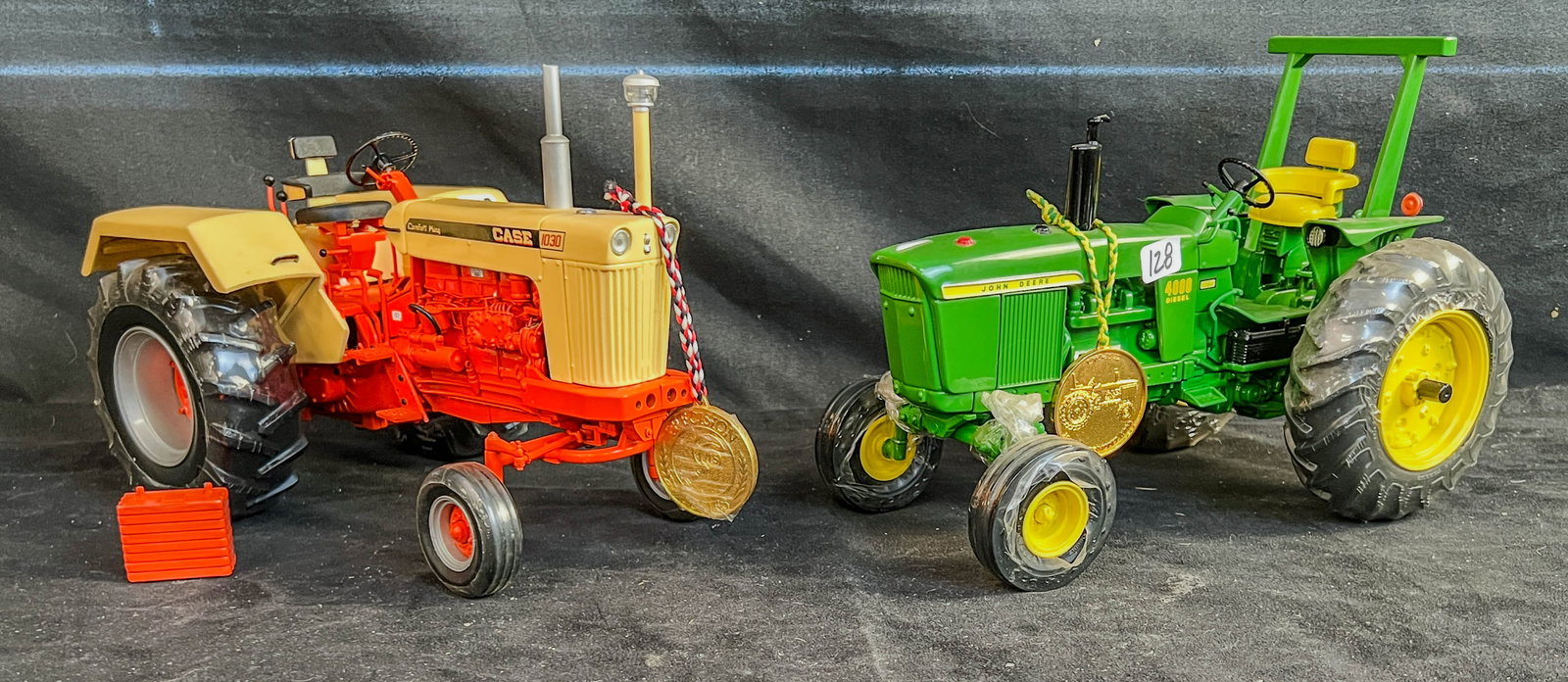 2 Ertl Die Cast 1/16 scale Precision Series Tractors, John Deere 4000 Diesel, Case 930 Comfort King: 2 Ertl Die Cast 1/16 scale Precision Series Tractors to inlcude a John Deere Wide Front 4000 Diesel precison Classic with coin and shrink wrapped wheels, and a Case 930 Comfort King Precision Series w