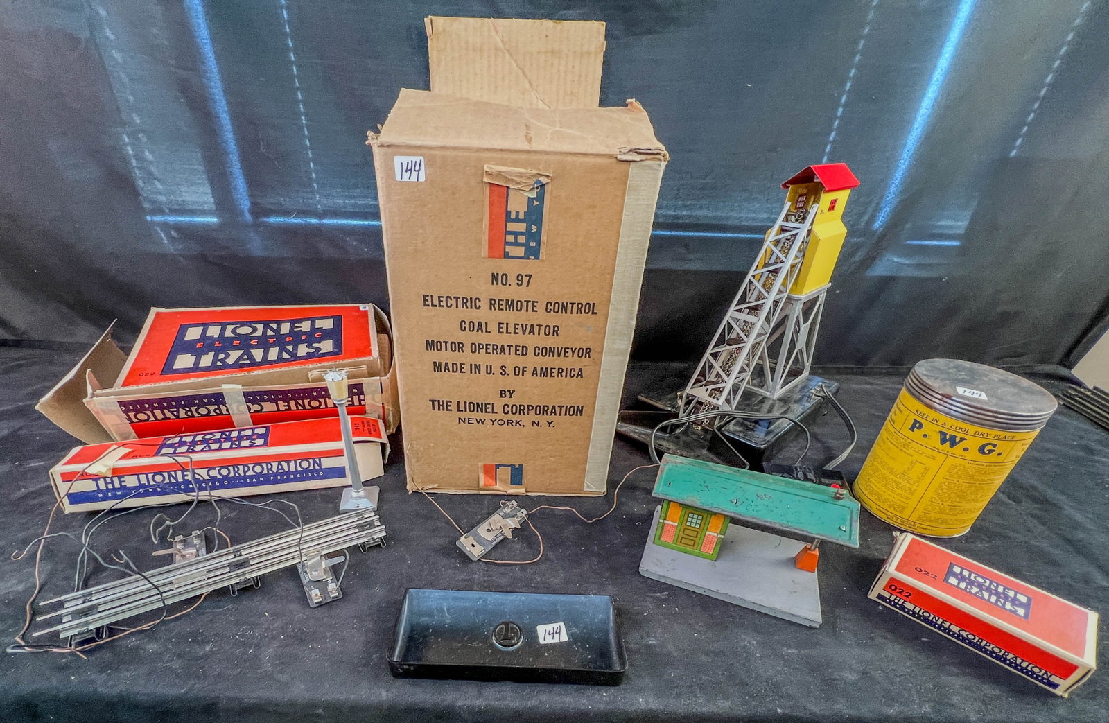 A Vintage group of LionelLionel Trains in Original Boxes: A Vintage group of Lionel Train Accesories in Original Boxes to include an O Gauge #97 Electric Coal elevator in its original Box c.1960-'s w/instructions, a half a tin of artificial coal, a #37 Metal