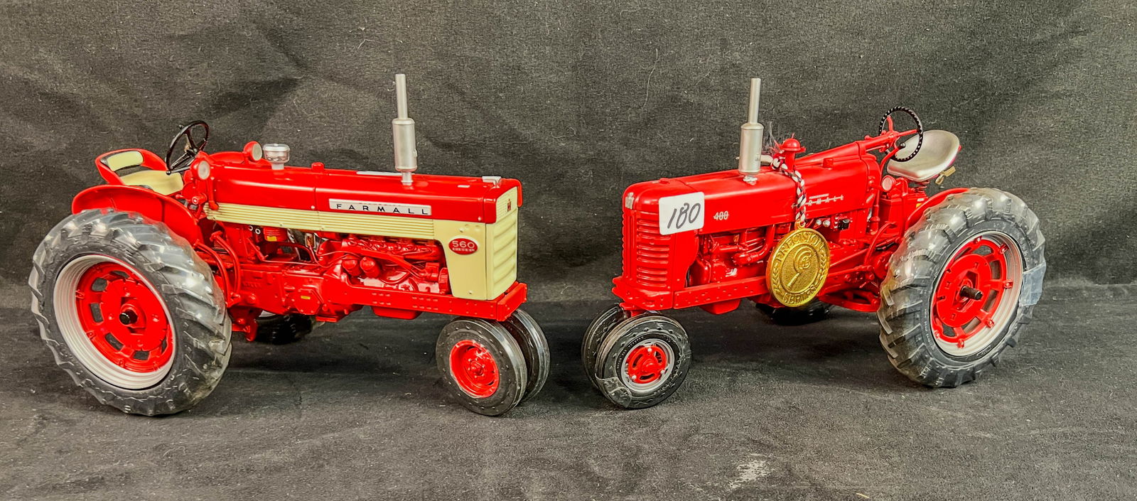 2 ERTL Farmall Die Cast 1/16 Scale Toy Tractors, Precision Series13 #400 Diesel, Prestige 560: 2 ERTL Farmall Die Cast 1/16 Scale Toy Tractors to include Precision Series13 #400 Diesel with it's gold coin, and a Prestige 560 Narrow Front. Both in unnused condition wtih factory wrapped wheels.