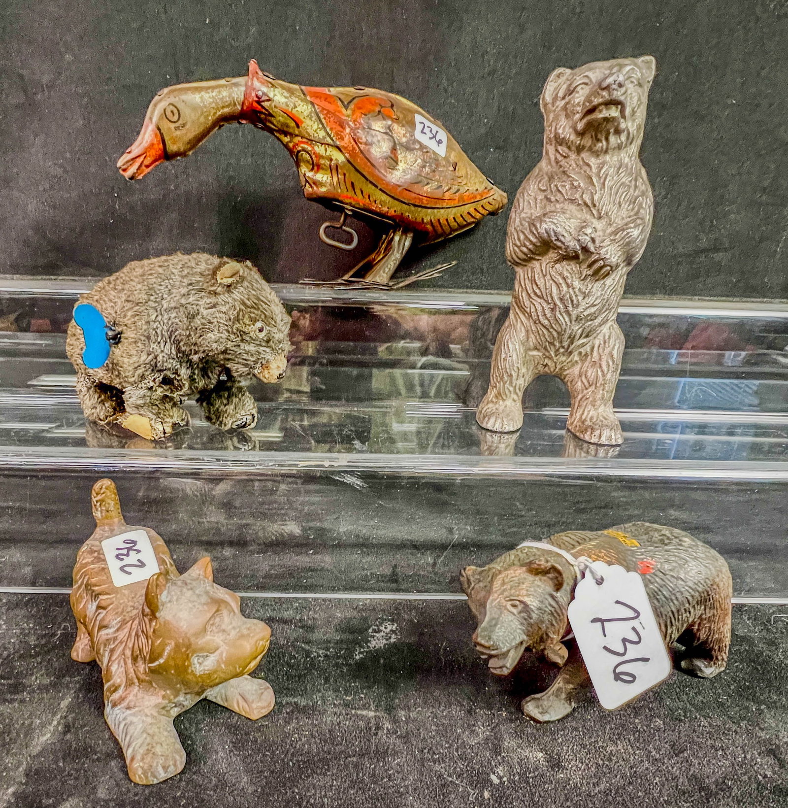 Antique Animal Toys, Marx Keywind Goose, Bear Bank More!Early 1900's: A group of antique animal toys to include a 1924 Louis Marx 5" tall Keywind Golden Goose, a 6" tall cast white metal Bear Bank c.1910, a 2.5" tall Schuco clockwork wind up bear c.1950's, a cast metal