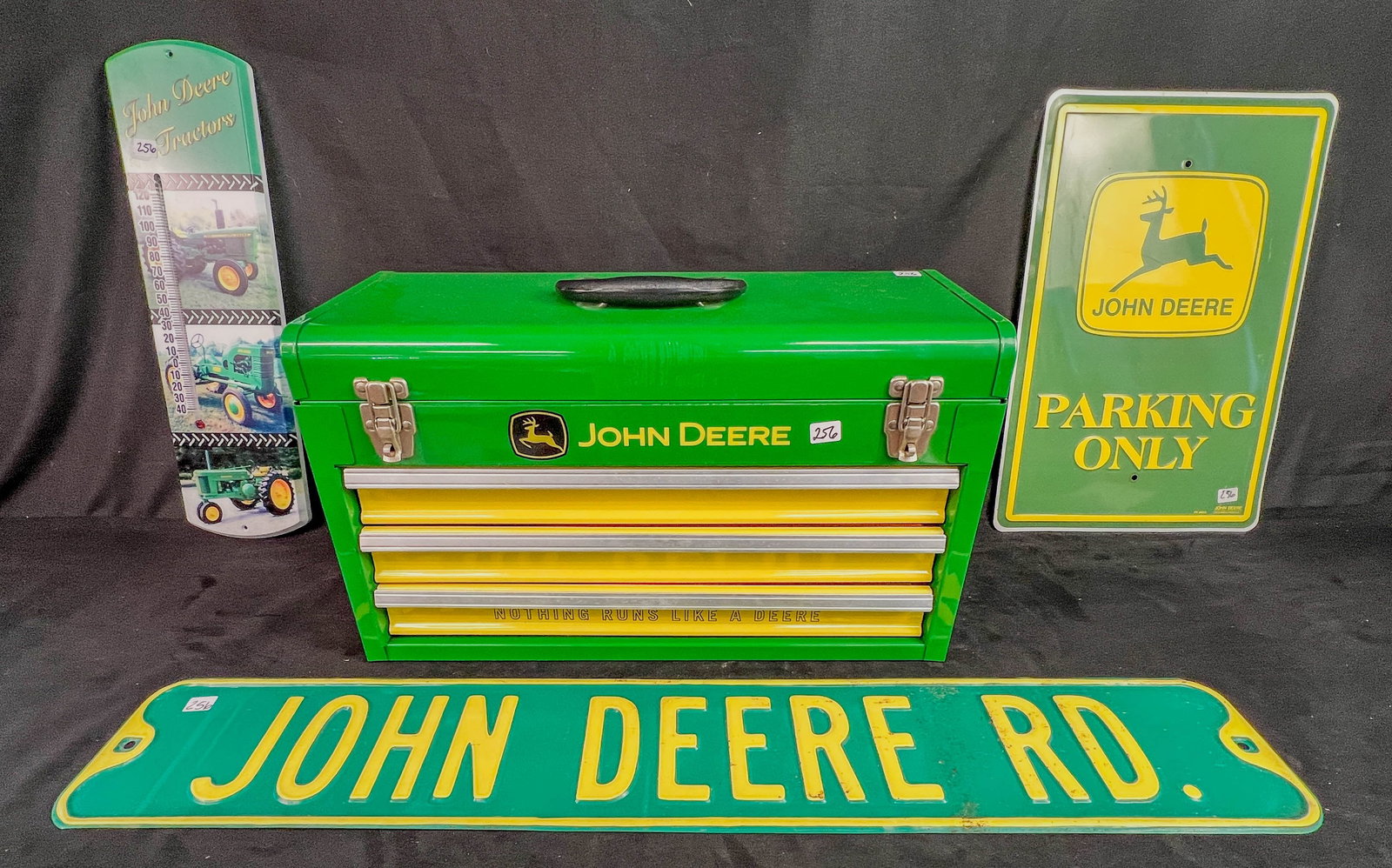 John Deere man Cave tin Memerobilia, Toolbox, Garden Thermometer, signs: John Deere man Cave tin Memorabilia to include an unused 3 drawer toolbox with flip top (12" tall X 20.5" across X 8.5" deep), a plastic John Deere garden thermometer , a John Deere street sign, and s