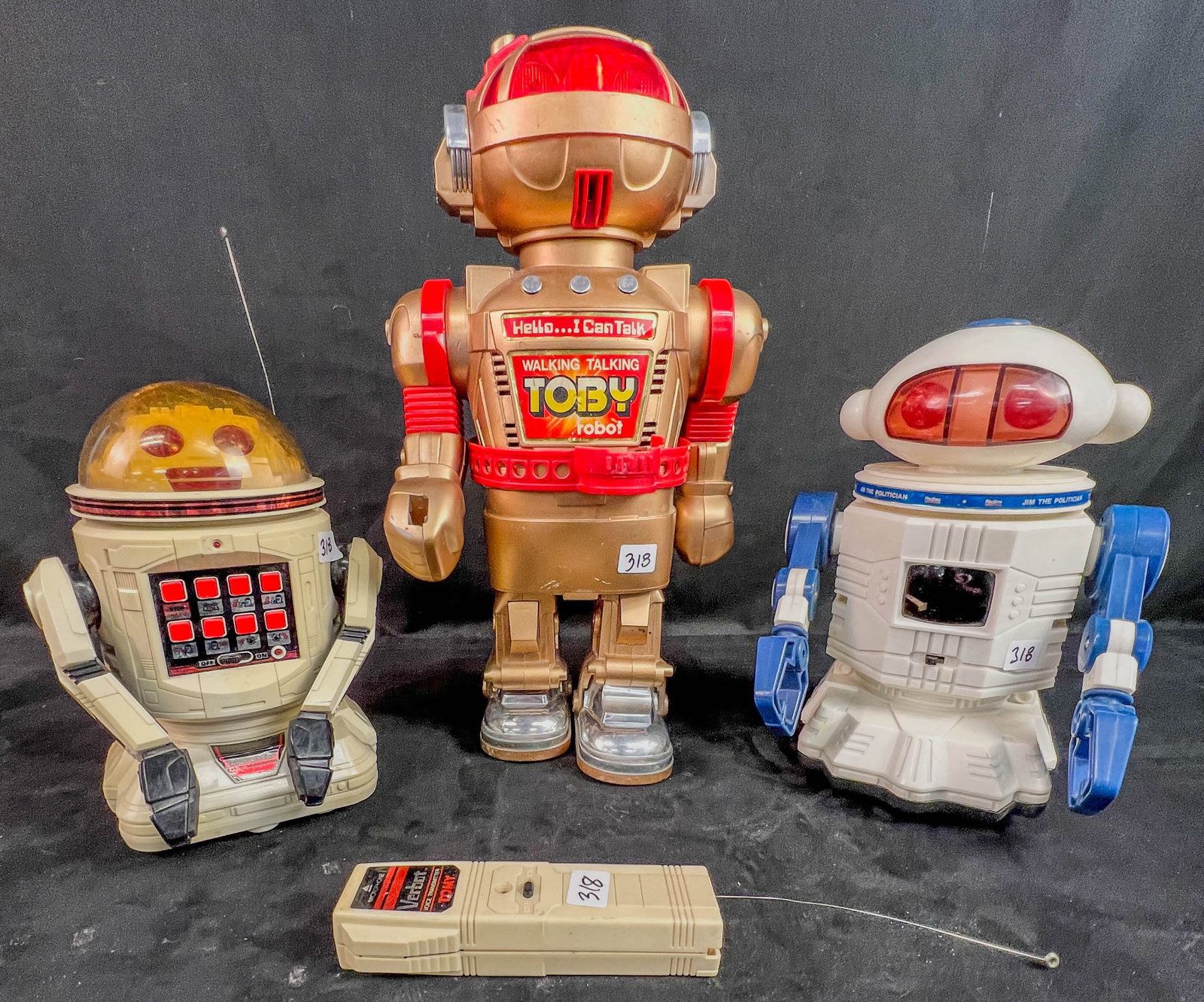 VIntage Plastic Robots, Tomy Verbort, New Bright Toby , More! C.1980's: A group of 1980's plastic battery operated moving robots include a 9" tall TOMY Verbot with its.s remote control, a 15" tall Walking Talking Toby (missing ray gun), and a 9.5" tall Playtime Jim the Po