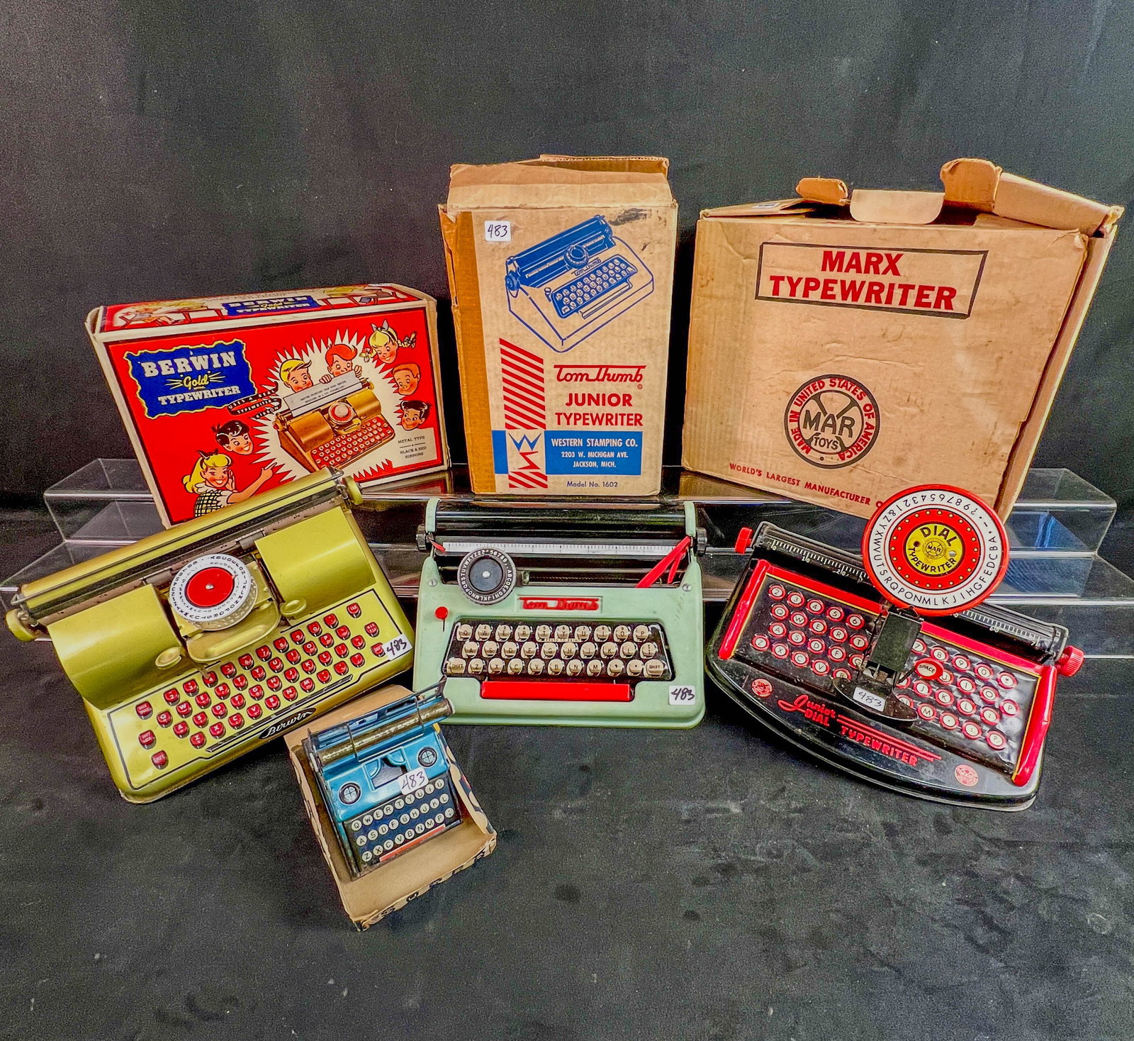3 !950's Toy Typewriters in orignal boxes, Marx, TOm HTumb, Berwin: 3 Vitnage tin Litho typewriters in their orignal boxes to include: a Marx Junior c1950's (tear to box), a Berwin "Gold" in excellent condition, and a Western Stamping Company "Tom Thumb" (ribbon is br