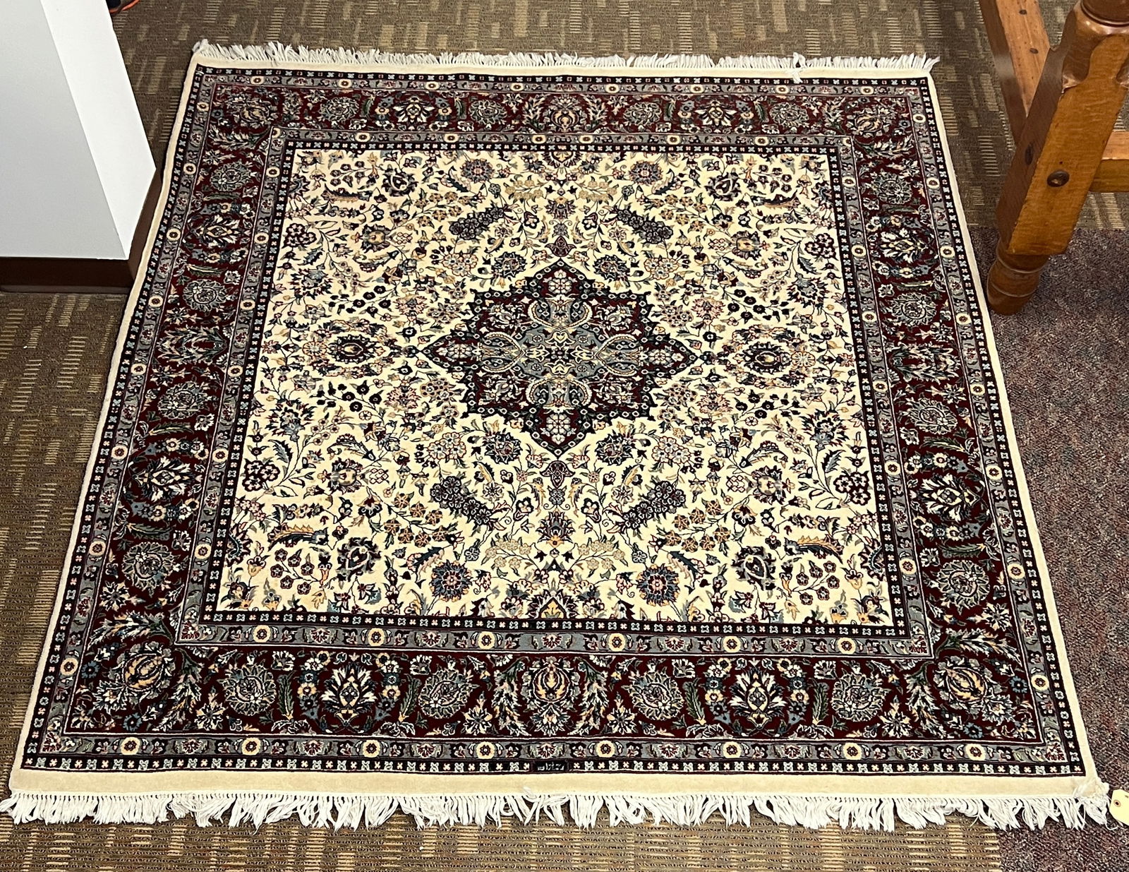 A High Quality Middle Eastern Hand Tied Oriental Rug: A high quality middle eastern hand tied oriental rug, in silk and wool mix, with five borders, and an elaborate full field floral in creams, burgundies, and blues. This rug in excellent like new condi