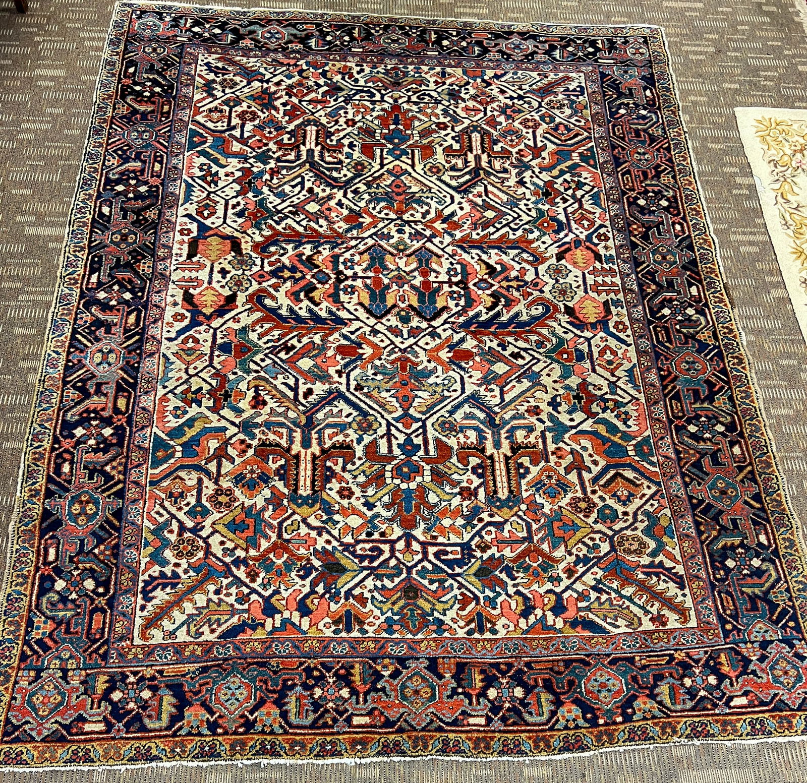 Antique Persian Tribal Room Sized Rug: An antique hand tied Tribal wool semi floral and geometric pattern carpet with a three border edge in excellent condition considering its age, 1880-1900 in burgundies, cream, umber, and blue. It measu