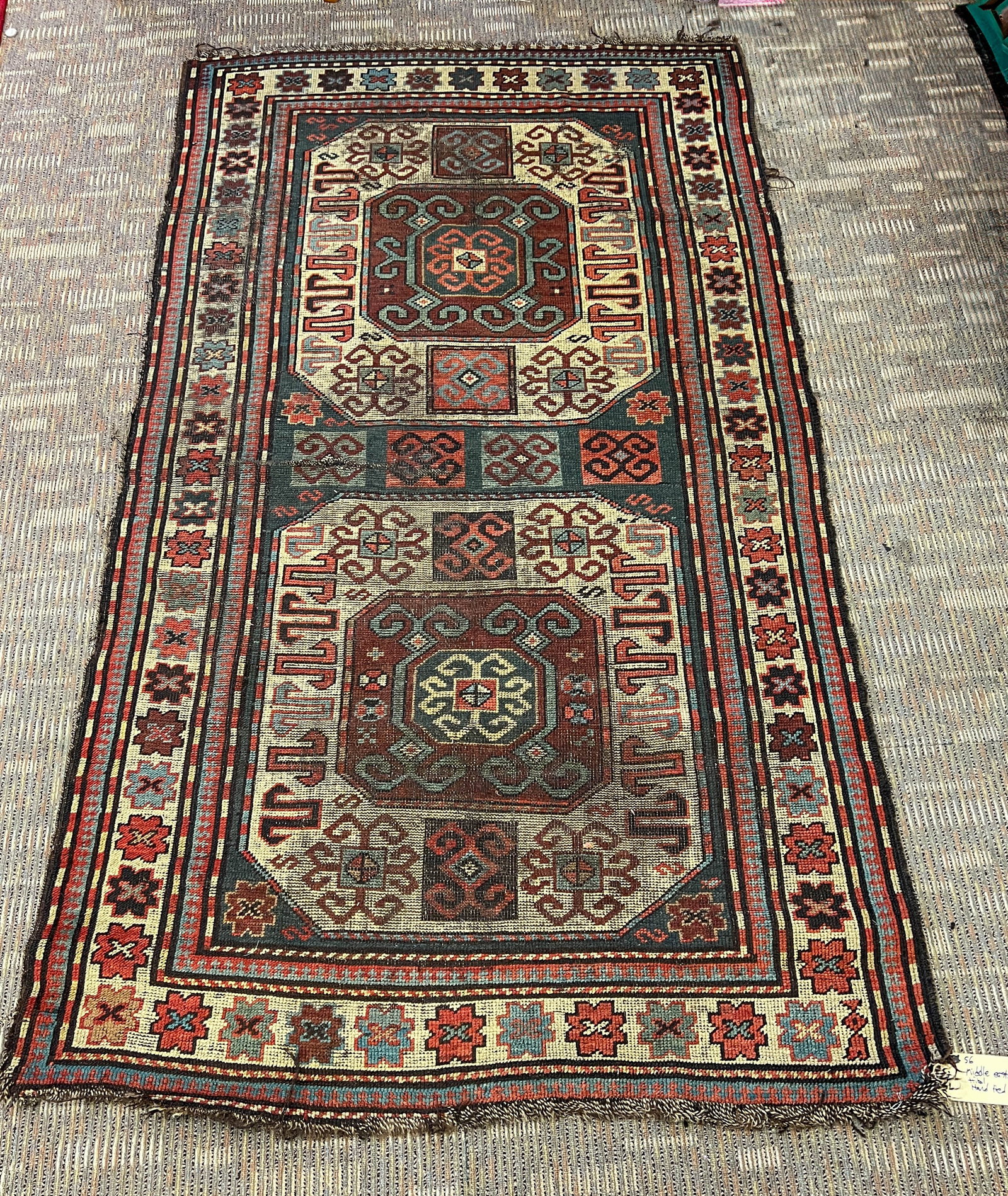 Antique Persian Hand Tied Tribal Rug: Eight border edging with a geometric center field in creams, greens, blues, burgundies, and umber. This antique rug is in fair condition considering its age 1890-1900. It measures 7' x 4.2'
