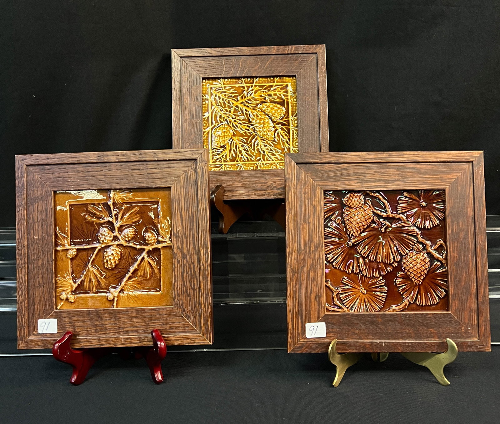 Mission Arts and Crafts Framed Tiles: Fumed Oak framed mission northwest pinecone tile in light brown it measures 9" tall x 9" wide x 1" deep. Secondly, a fumed oak frame Wisconsin pinecone branch in dark brown tile it measures. Thirdly, 