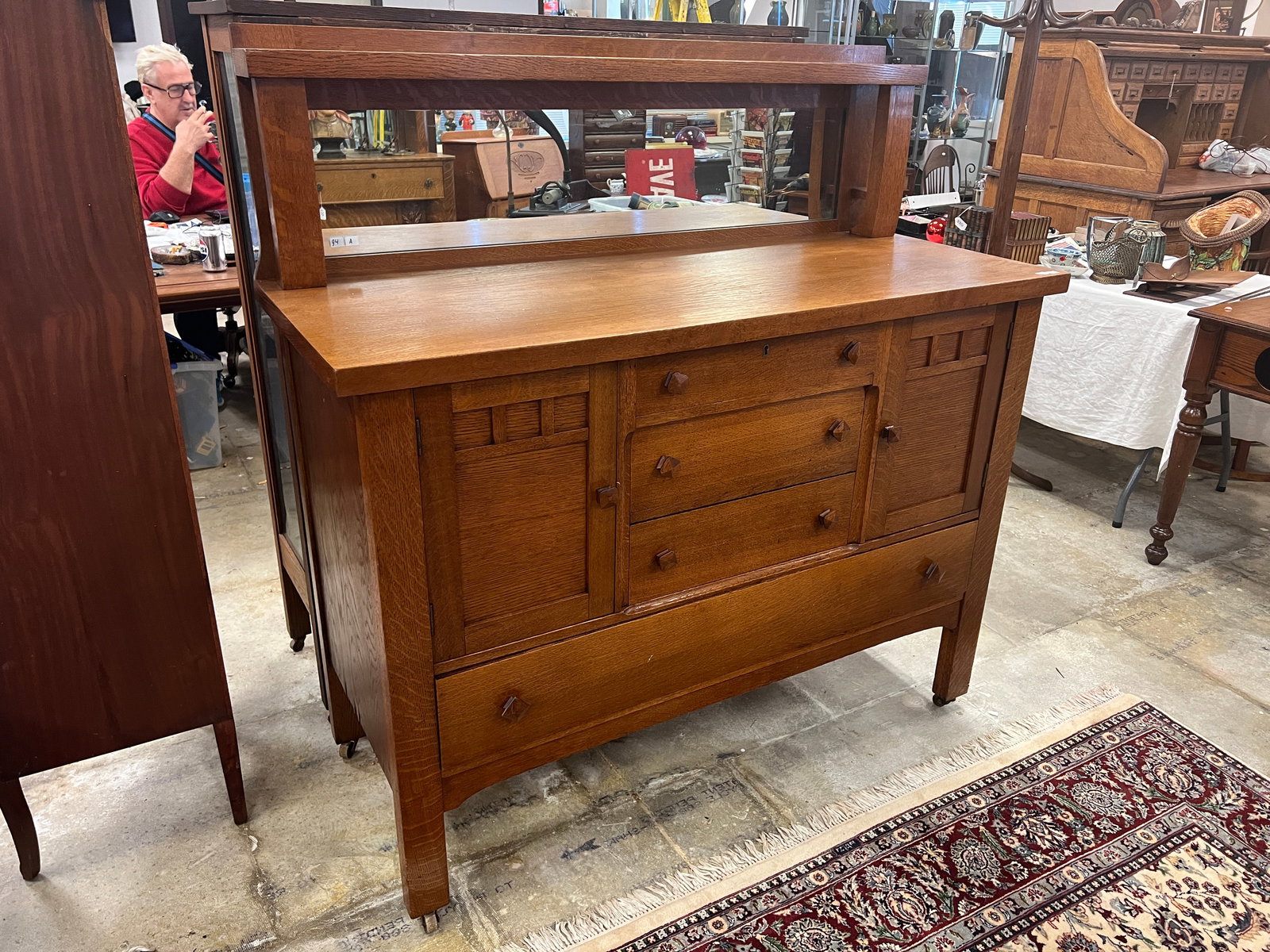 Mission Arts and Crafts Oak Buffet: Mission arts and crafts oak buffet with mirrored back with compartment and drawer base. It is in its original finish and retains all of its original square knobs. It measures 54" tall x 54" wide x 22"