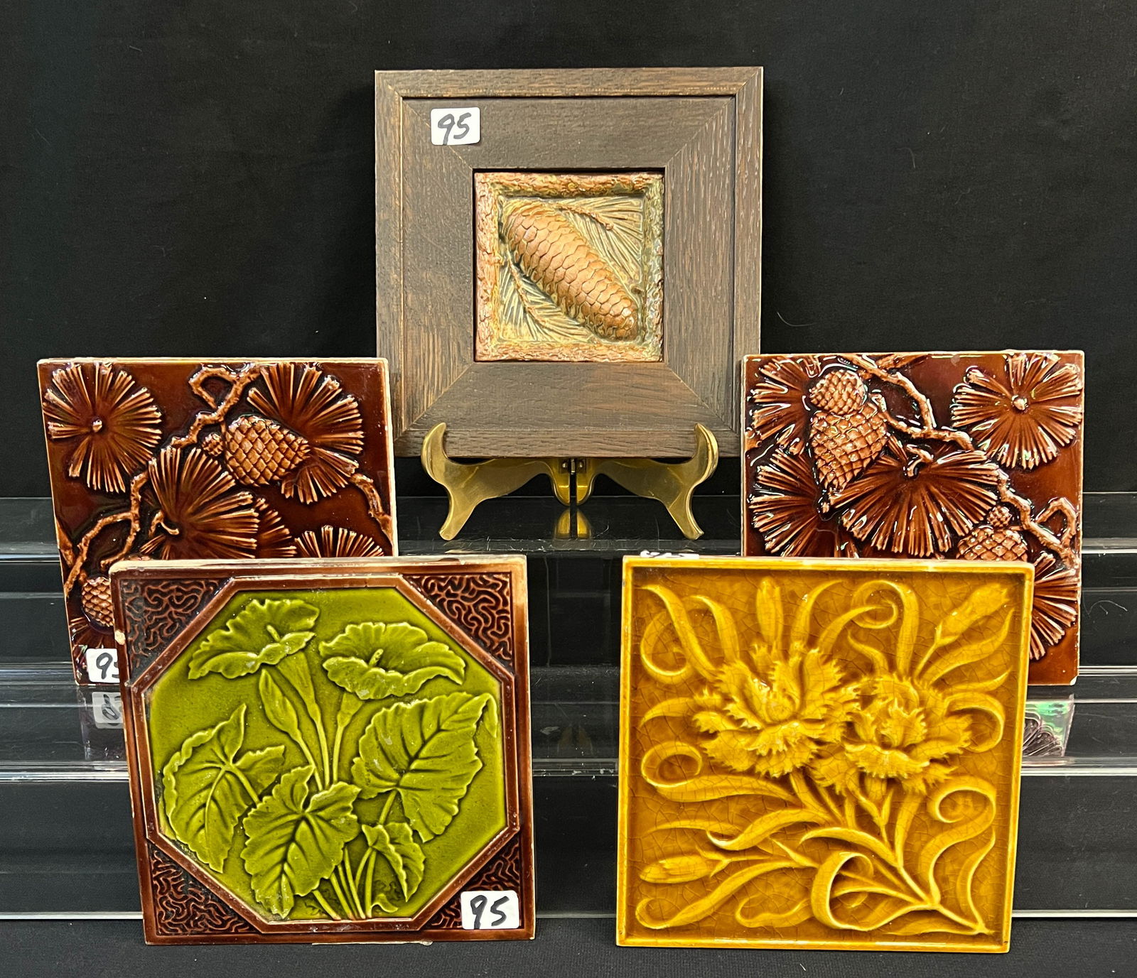Mission Arts and Crafts Five Tiles, Minton, and More: Mission arts and crafts tiles to include: an oak framed pinecone tile, and four unframed tiles to include 2 Minton China Co. tiles depicting flowers and pinecones, a Minton mustard floral tile. The fr