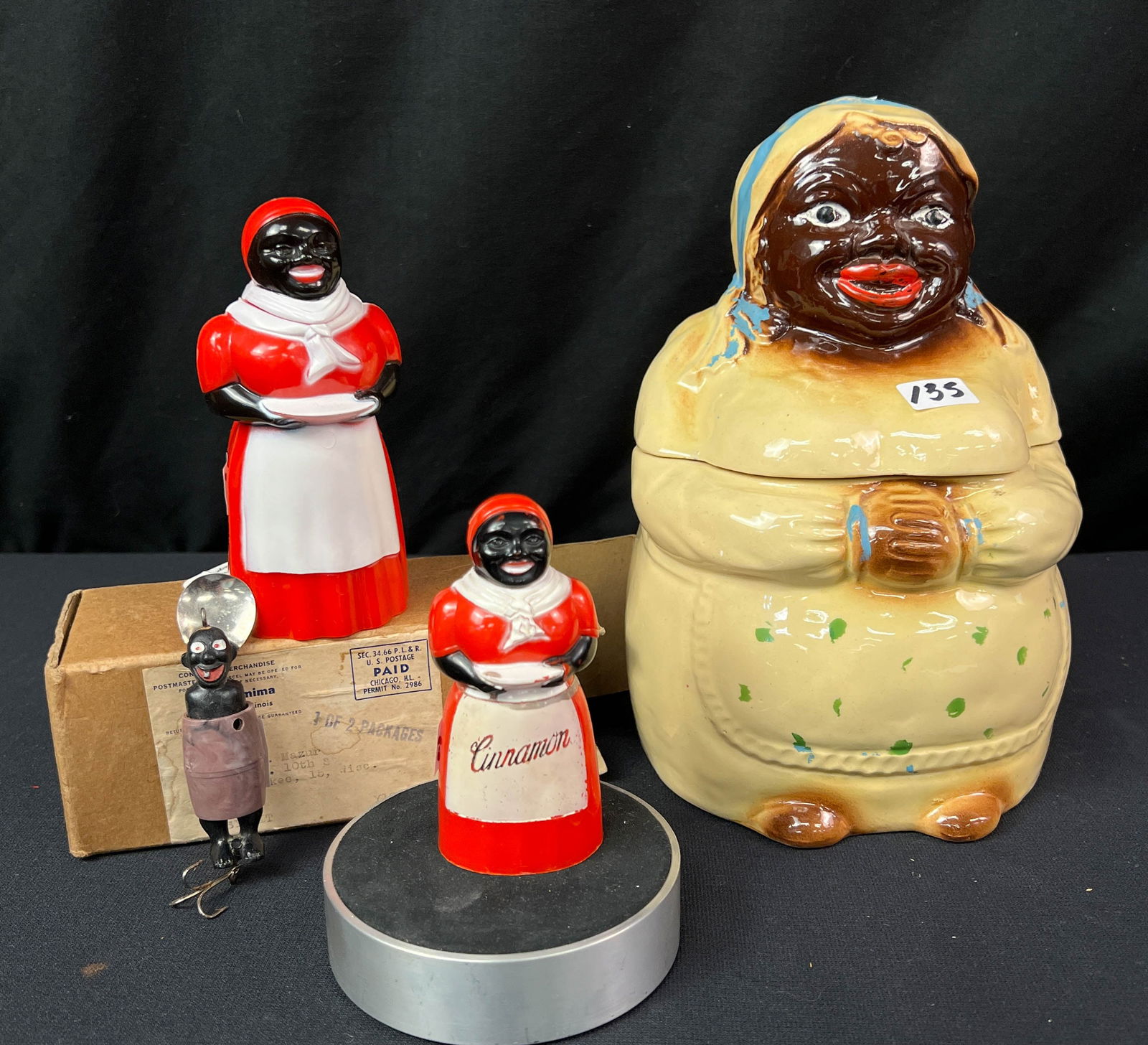 A Group of Black Memorabilia: A Group of Black Memorabilia to include a USA. RS. company black mammy cookie jar measures 9" tall x 7" wide, a black mammy syrup container with original mailing box from aunt Jemima that measures 5.5