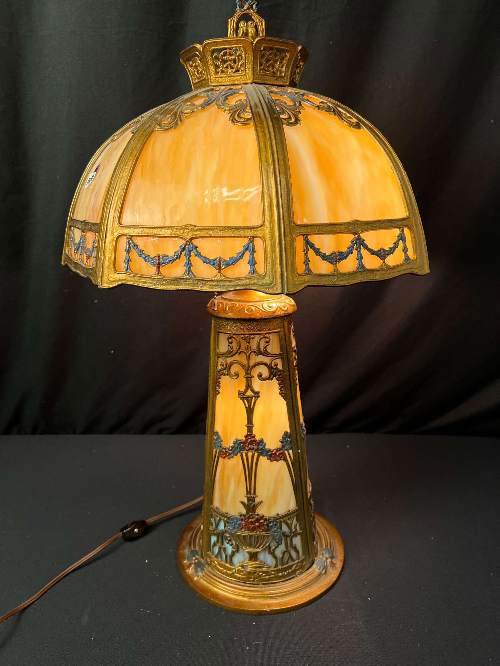 1900s Fancy Filigree Caramel Slagged Table Lamp: 1920s table lamp with elaborate filigree depicting vases with garlands and in set curved caramel slagged glass, This 1920 table lamp has a caramel slagged filigreed shade eight panel shade and caramel