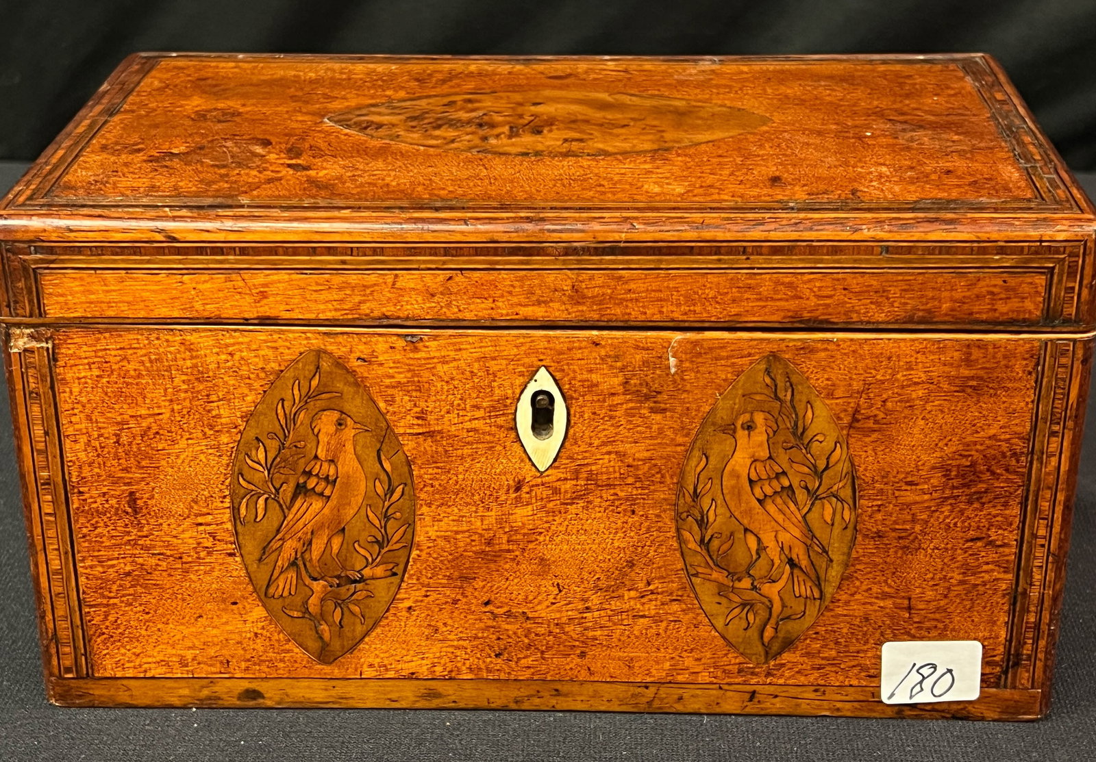 An 18th Century Bird Inlaid Tea Box: An antique 18th century inlaid bird tea box in mahogany with string inlays with mother of pearl key cover. It is in excellent condition it measures 5" x 6" x 5"