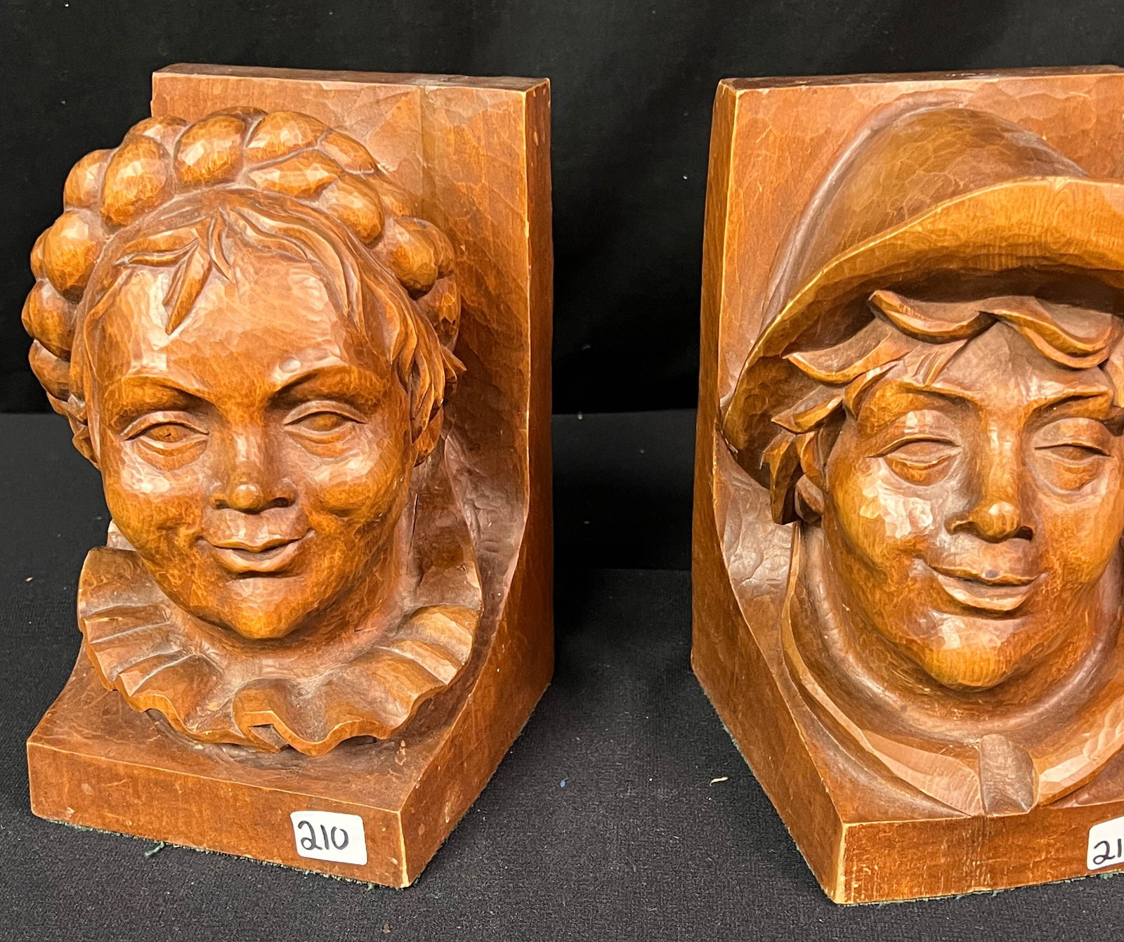 Black Forest Busts of a Man and Woman Artist Signed: Black Forest hand carved mahogany bust bookends of a young peasant woman and a young peasant man and they measure 8" x 5" x 5". Female bust market Oberammergau 1953, and male has an artist mark. Both 