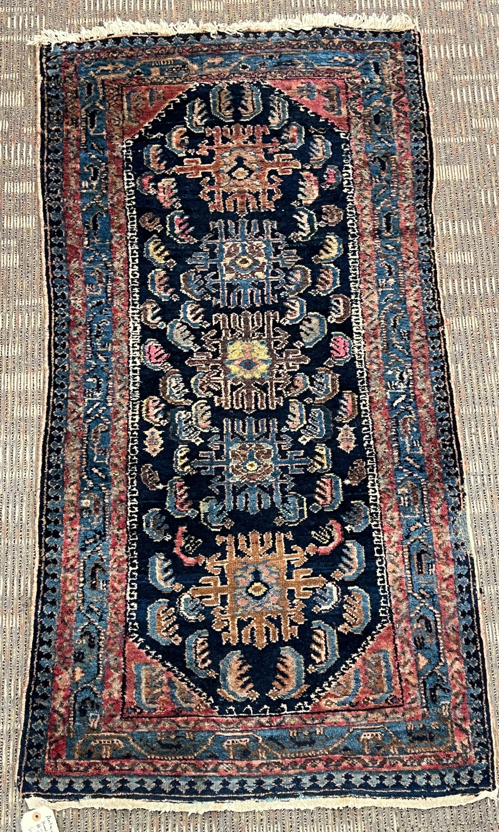 Antique Turkish Tribal Hand Tied Rug: Antique hand tied tribal Turkish rug with six border edging with overall geometric pattern in blues, burgundies, greens, and browns. This antique hand tied tribal Turkish rug measures 60" x 32"
