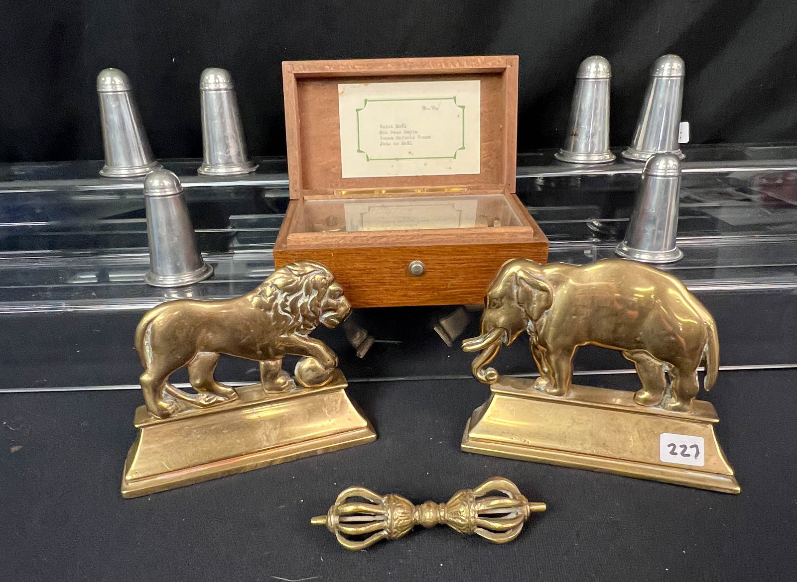 English Brass Lion and Elephant Fireplace Ornamentals C.1850, More!: A finely polished pair of solid brass English chimney ornaments c.1850 that features an elephant and lion. Also included are a fancy brass knife rest. A St. Pierre inlaid music box needs repairs. A 6"