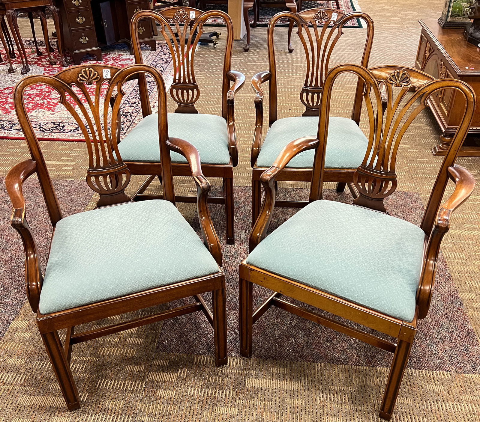 A Set of Four Mahogany Arm Chairs: A set of four mahogany federal style arm chairs with floral carvings and pierced backs. They are in excellent condition and are house ready. They measure 38" x 22" x 17"