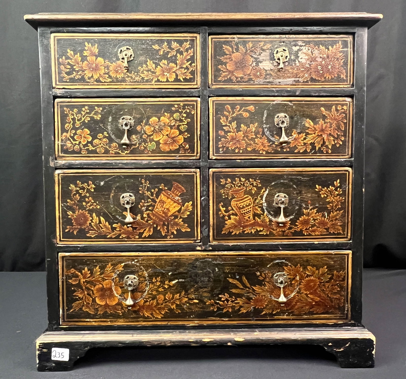 English 7 drawer spice Cabinet c.1850: An antique English 7 drawer demure cabinet c1850s. This seven drawer spice chest has hand painted urns and flowers with miniature teardrop pulls.
