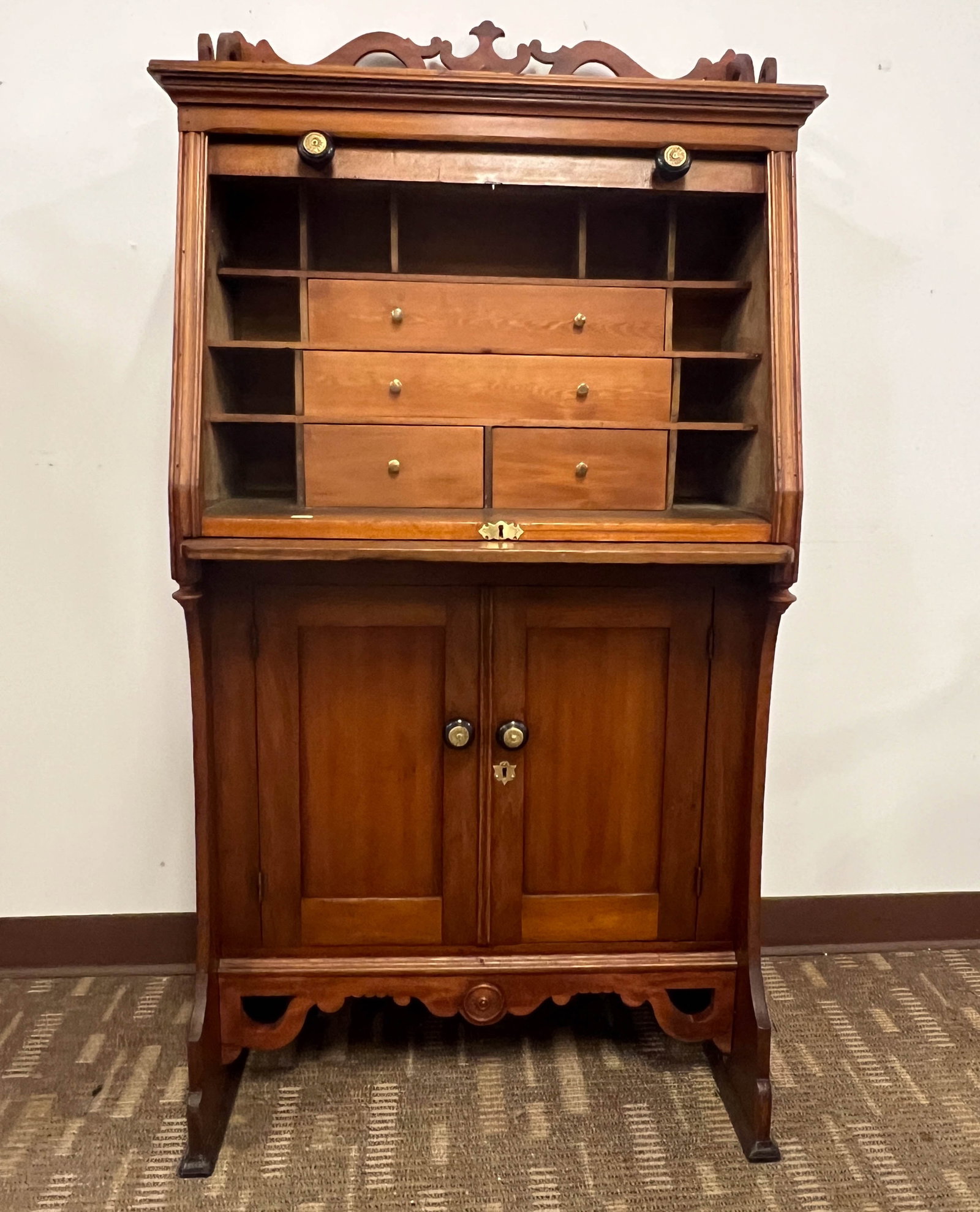 Roll Top Ship Captain's Desk c.1880/90's: 1890s - 1900s Roll Top Ship Captain's Desk with elaborate pierced carved back slash with double door base with applied carving and fitted interior. This unusual desk is purportedly off of a Lake Michi