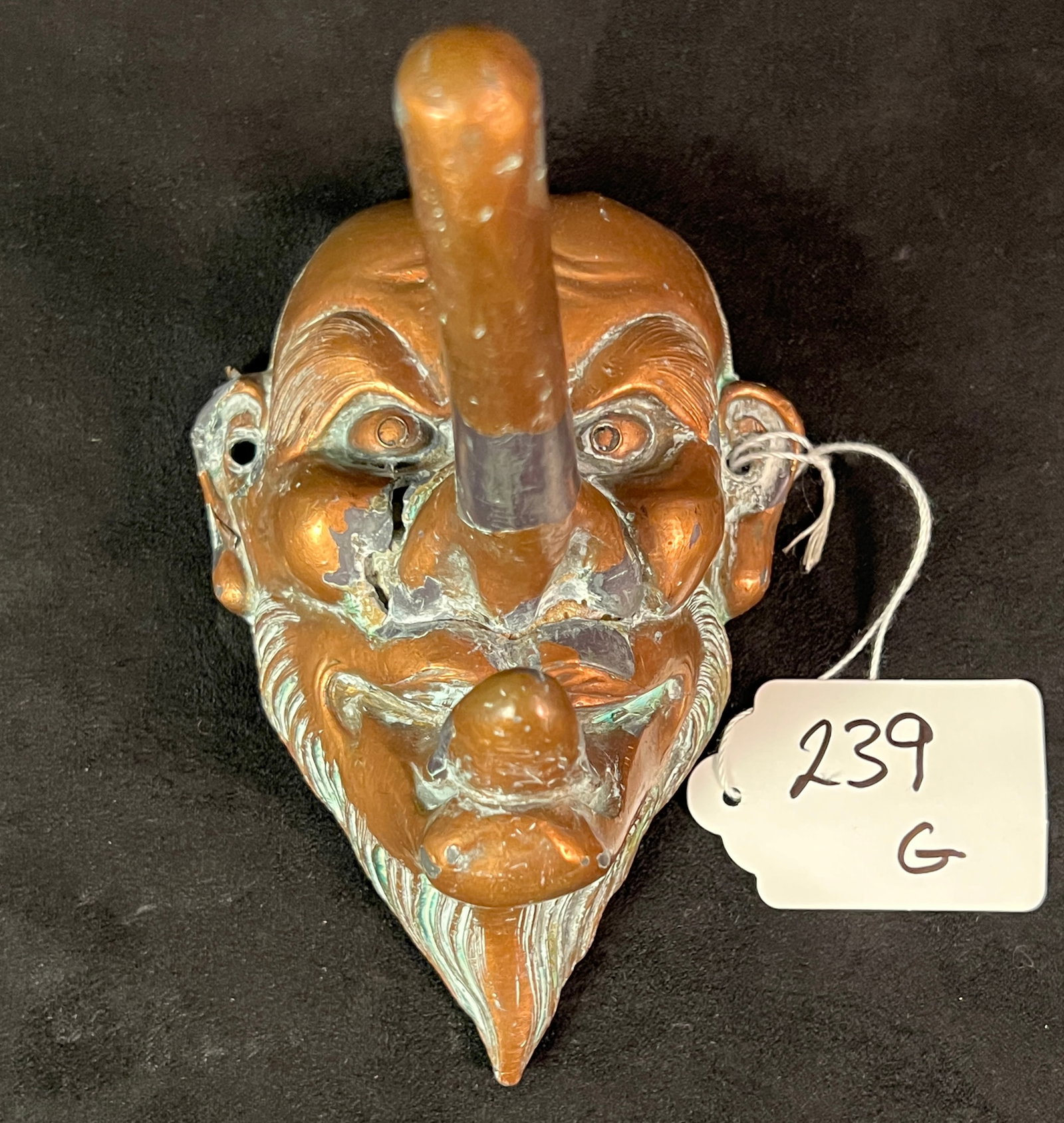 19th Century Bronze Tengu Mask and Brass Gong: A group of 19th century Oriental metal pieces to include a bronze brass covered Tengu mask folkloric wall pocket (5.5" tall X 3.5" across), and a hand tooled bronze gong and mallet with floral decorat