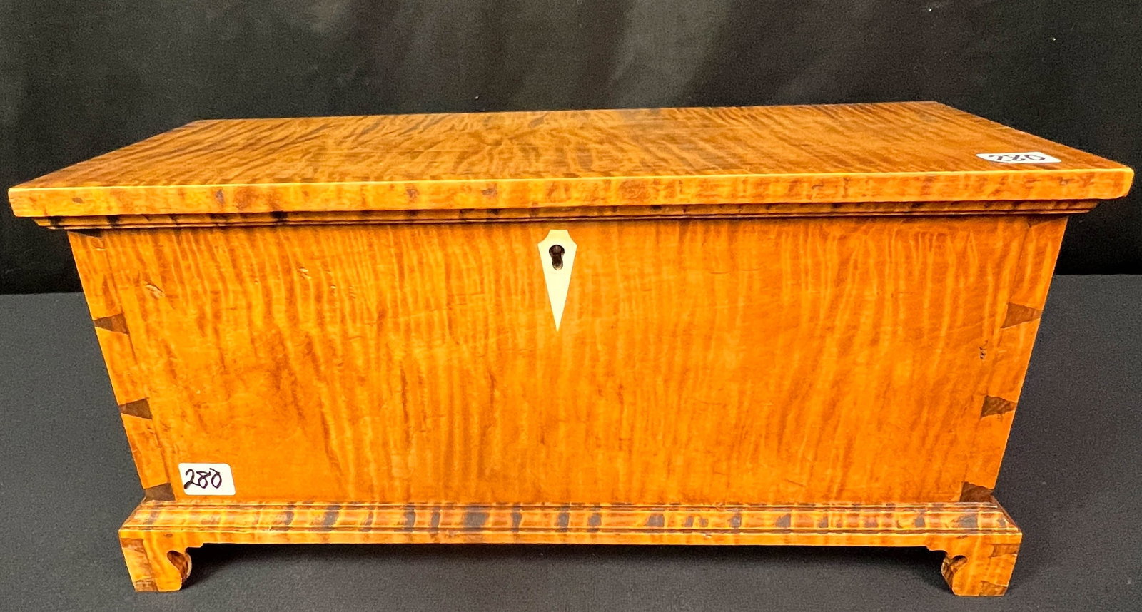 R H Haffner St College PA 2004 Miniature Chest: R H Haffner St College PA 2004 Miniature Chest. In tiger stripe maple on bracket feet, pencil edge dovetailing, and in original condition. It is house ready and measures 7.5" x 15" x 6.5"