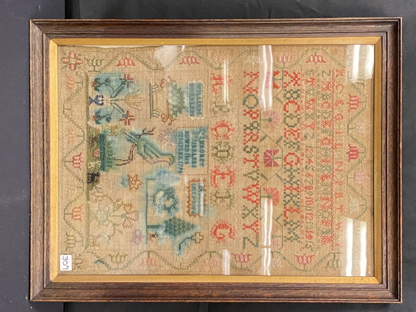 An American Sampler C.1790: An antique American child's sampler C.1790 by Margret Mirblees to include her parents' names "William Mirblees" and "Isabella Salmon", a floral border, multiple alphabetical fonts, numbers, multiple b