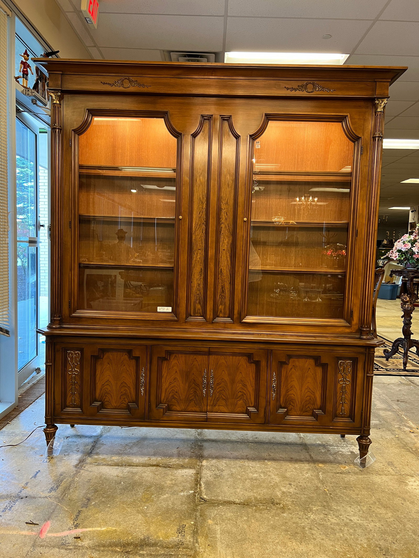 Romweber French Rosewood and Walnut China Buffet: Romweber French Rosewood and Walnut China Buffet with bronze ormolu trim, pillared front, and chamfered panel compartment space. This quality rosewood and walnut oversized China cabinet display lights