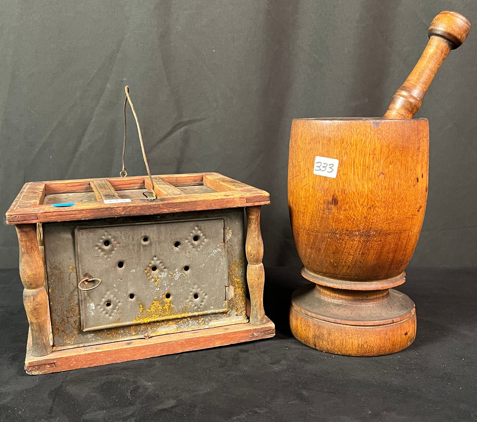 Early American Tole Foot Warmer Along With A Wood Mortar and Pestle: An early American tole foot warmer with punched tin center, turn post, and wood surround with bailed handles. It measures 5.75" x 9" x 7.75. Also included an early turned wood mortar and pestle. Pestl