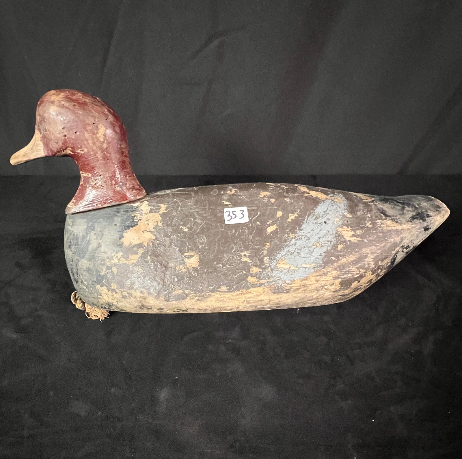 A Hand Carved Wooden Duck Decoy In Original Paint: A Hand Carved Wooden Duck Decoy In Original Paint. It is in fair condition. This decoy measures 12" x 16.5" x 7"