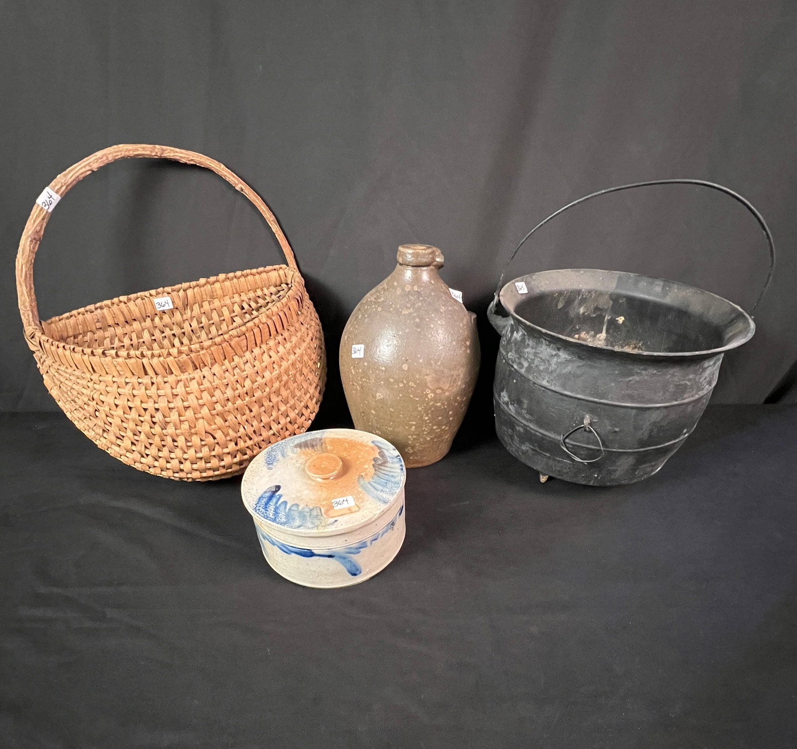 A Group of Early Primitives To Include Signed Hermann Jug, Stoneware Covered Butter, Iron Kettle,: A group of early primitives to include a signed stoneware 12" tall C. Hermann Milwaukee jug missing its handle, a blue and gray decorated stoneware covered butter that measures 4" x 7.5" round. An ant
