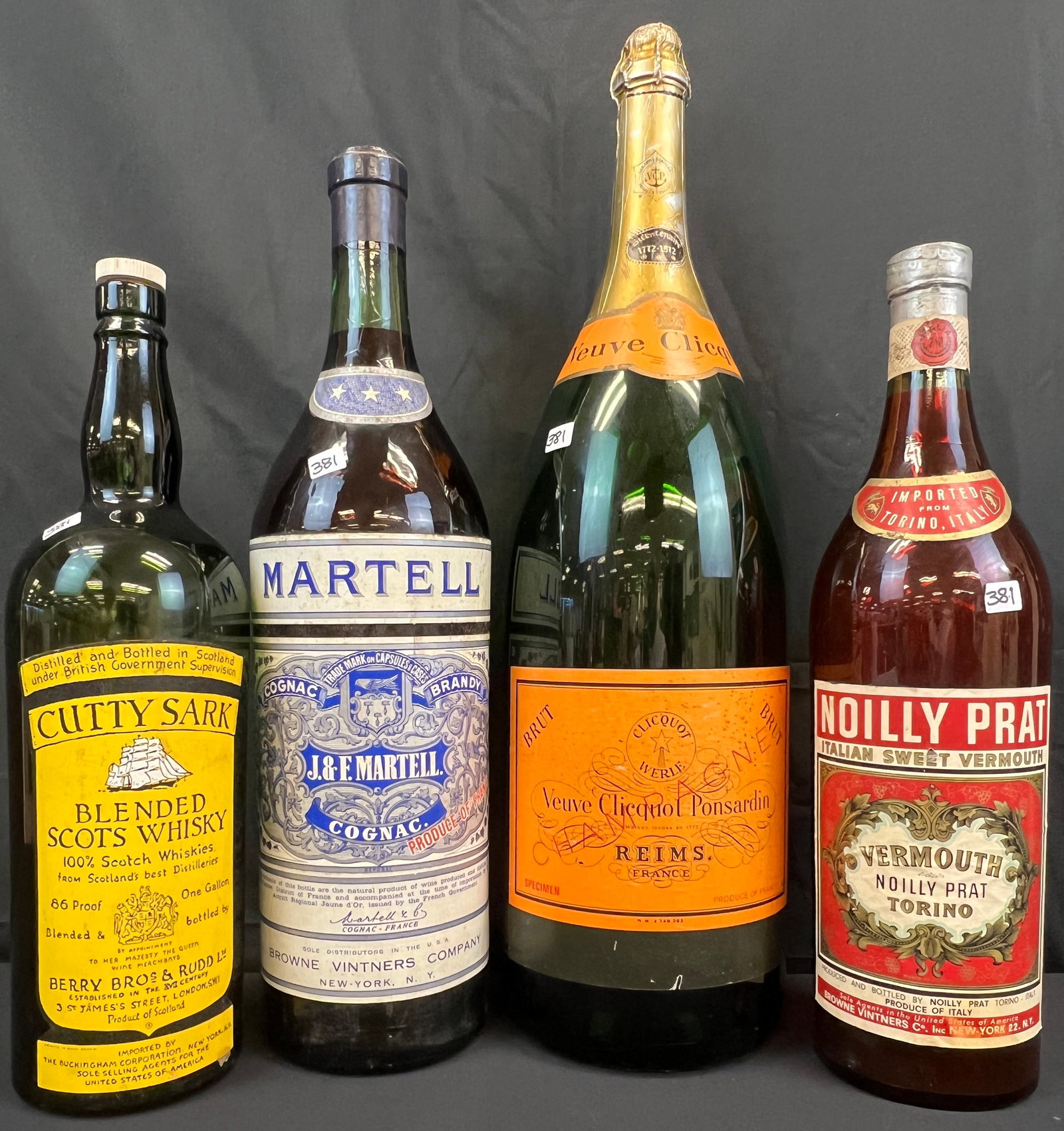 Four Large Display Liquor Bottles: A collection of four large display bottles to include a 1772-1972 Veuve Clicquot Ponsardin Reim. France Champagne bottle that measures 26.5" tall, a Martell Cognac Brandy J.&F. Martell display bottle 
