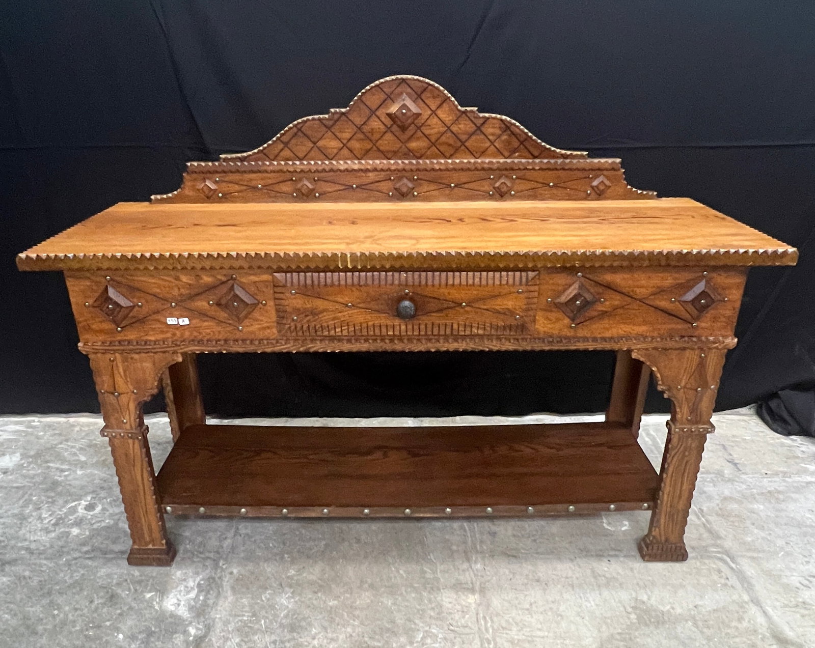 Chip Carved Oak Buffet: An oak chip carved buffet reminiscent of tramp art. This vintage piece is made by Broyhill and is marked on drawer. Overall has a distressed look and presents nicely, a well-made piece of furniture. I