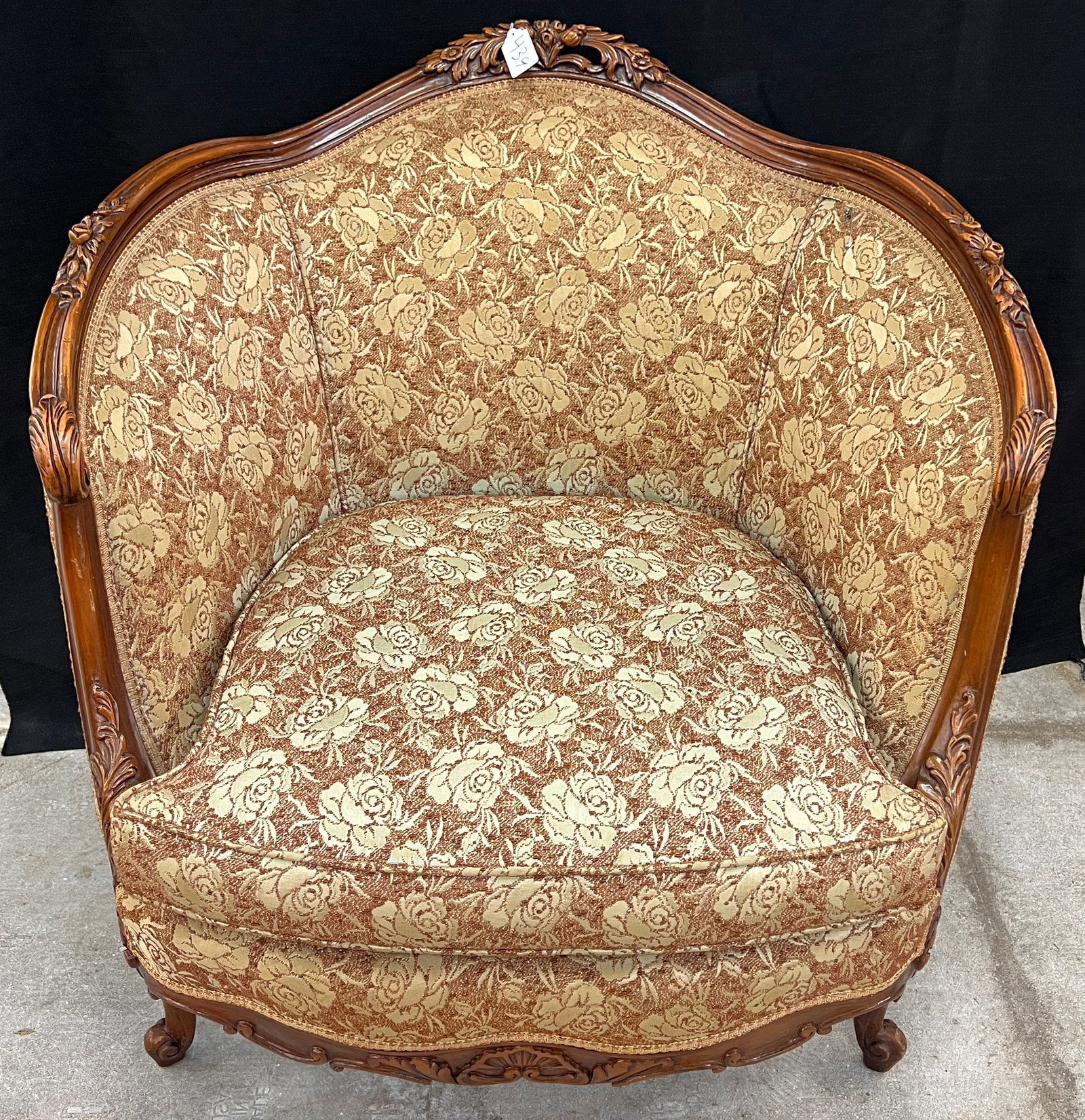 A 1920's Upholstered Floral and Pierced Carved Arm Chair That Matches Previous Lot: A 1920's upholstered floral and pierced carved arm chair with floral frieze. It is in excellent condition and measures 34" tall x 34" wide x 22.5" deep