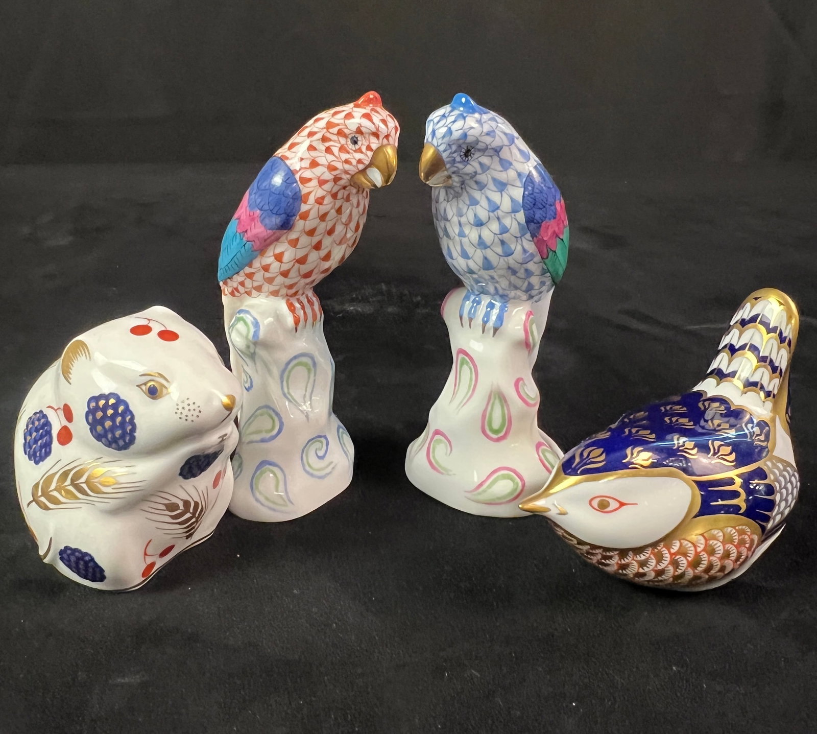 Group of Fine Porcelain Birds Figurines, Herrand, Royal Crown Derby: A group of fine porcelain bird figurines to include 2 matching 4.5" tall hand painted parrots by Herrand, a Royal Crown Derby 2.5" tall bird and 2.5" tall mouse. All in excellent condition.