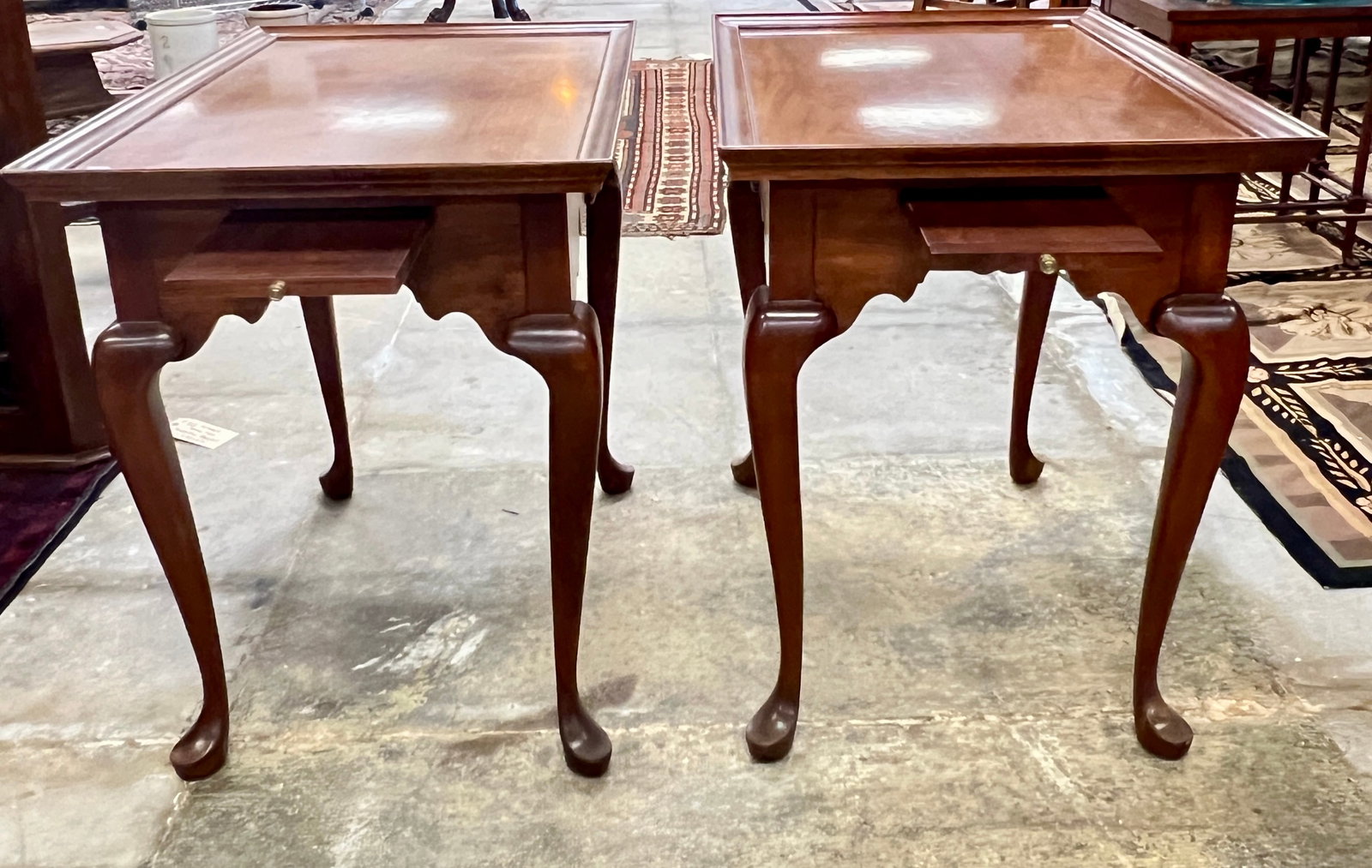 Pair of Queen Anne Side Tables with Candle Drawers: A pair of contemporary mahogany side tables with candle drawers and shell carving. Each table measures 26.5" tall X 30.5" across X 20.5" deep.