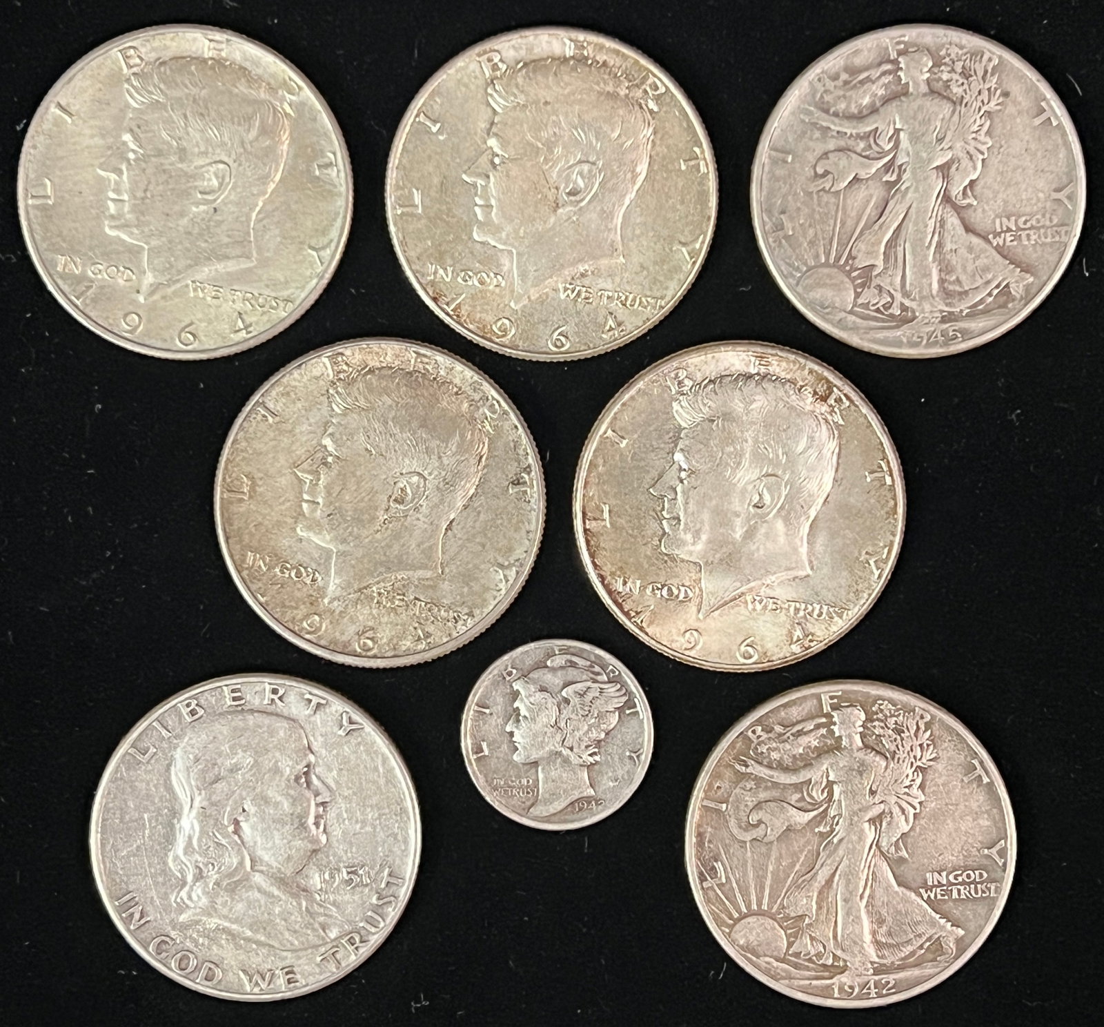 Group of Assorted Silver Coins: A group of silver coins to include the following: 1945 Walking Liberty half dollar, four 1964 Kennedy half dollars, 1942 Walking Liberty, 1951 Ben Franklin half dollar and a 1942 Mercury dime. Total w