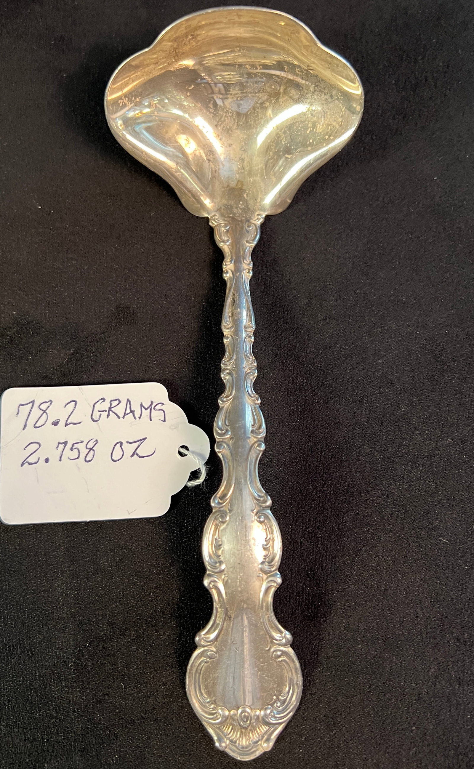 A Gotham Sterling Ladle: A sterling ladle in the Strawberry pattern that measures 6" long by 2.5" across and 2" deep it weights 78.2 grams
