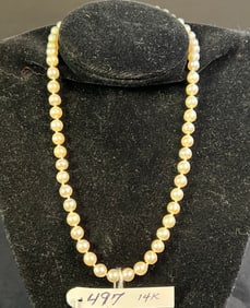 A Strand Of Natural Pearls With 14K Gold Clasp