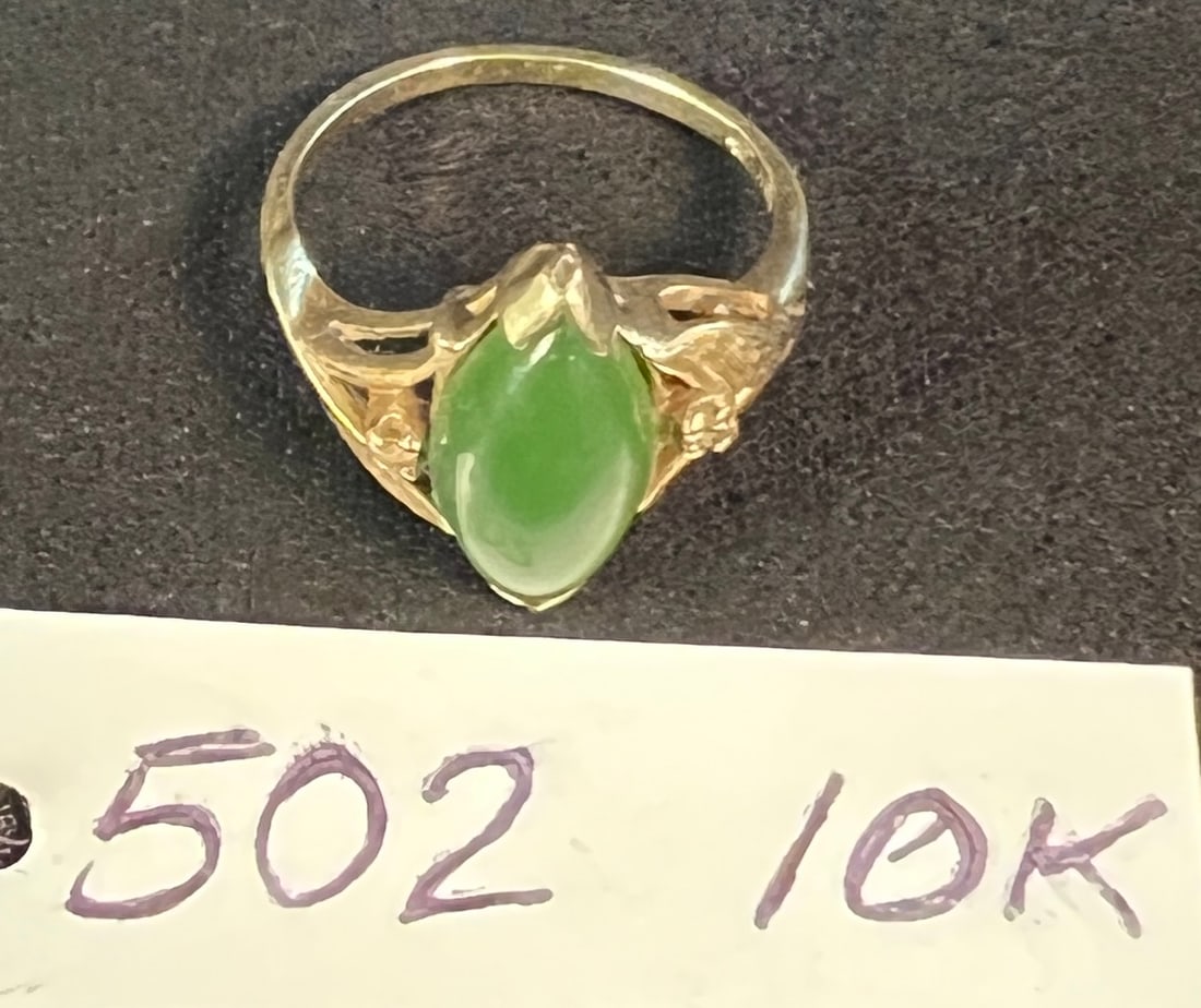 A 10K Yellow Gold and Green Jade Stone Ring: A 10K yellow gold and green jade stone ring that measures 4.5". It weighs 2.55g or with stone or .09oz. Scrap value is roughly $109.