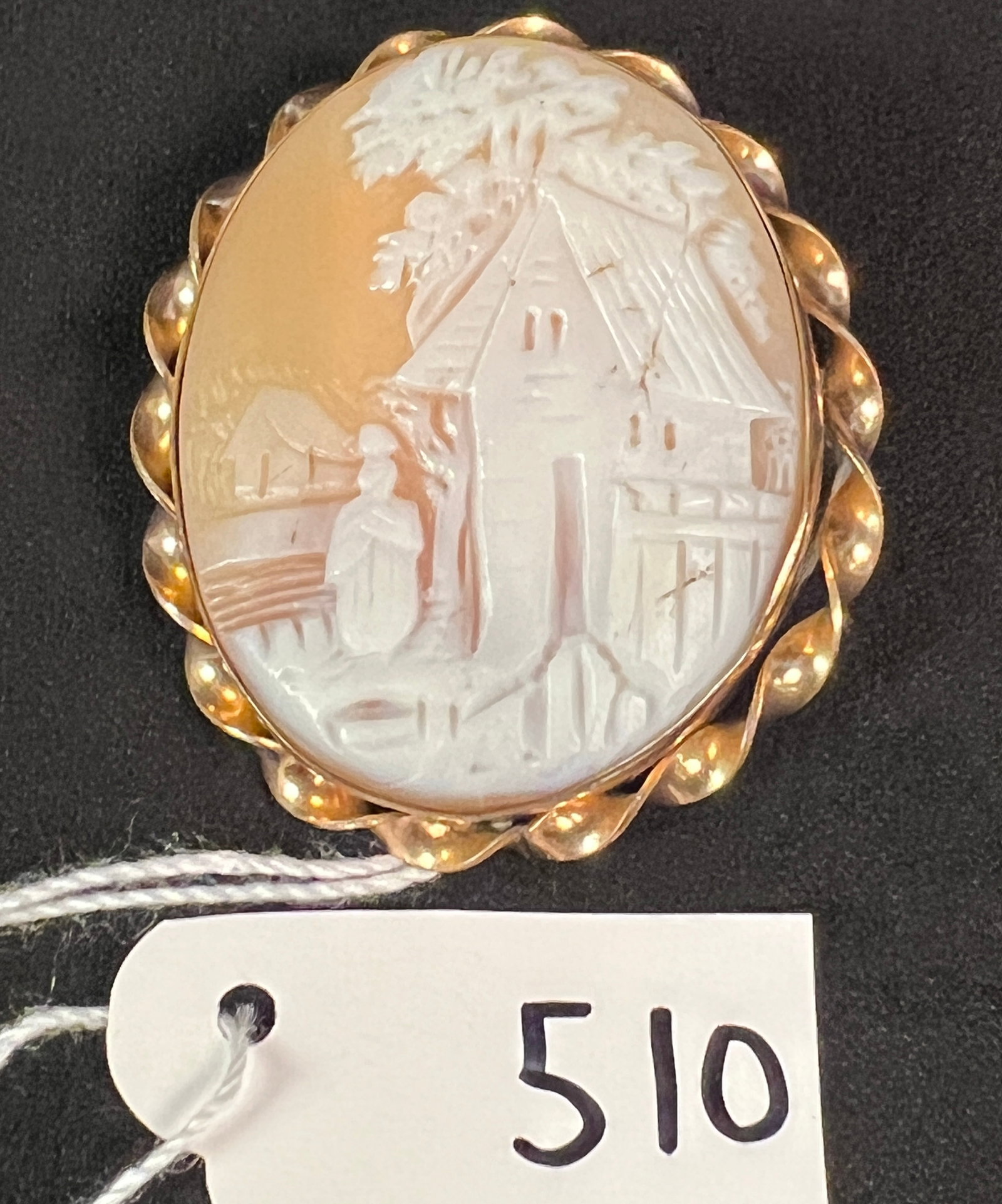 Rolled Gold Cameo of Village Scene: A rolled gold Victorian cameo with a carved scene depicting village and person in foreground. Measures 1.75" tall.