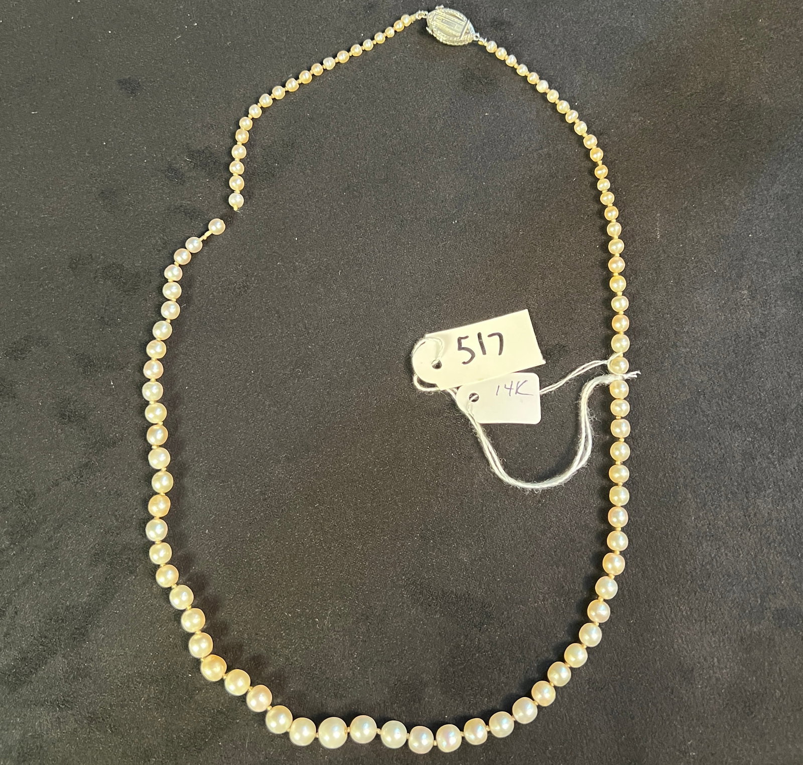 Edwardian String of Pearls with Diamond 14K Clasp: A very fine string of Edwardian pearls with a 14K and diamond clasp marked "Marcus". String of pearls is broken and would need to be restrung.