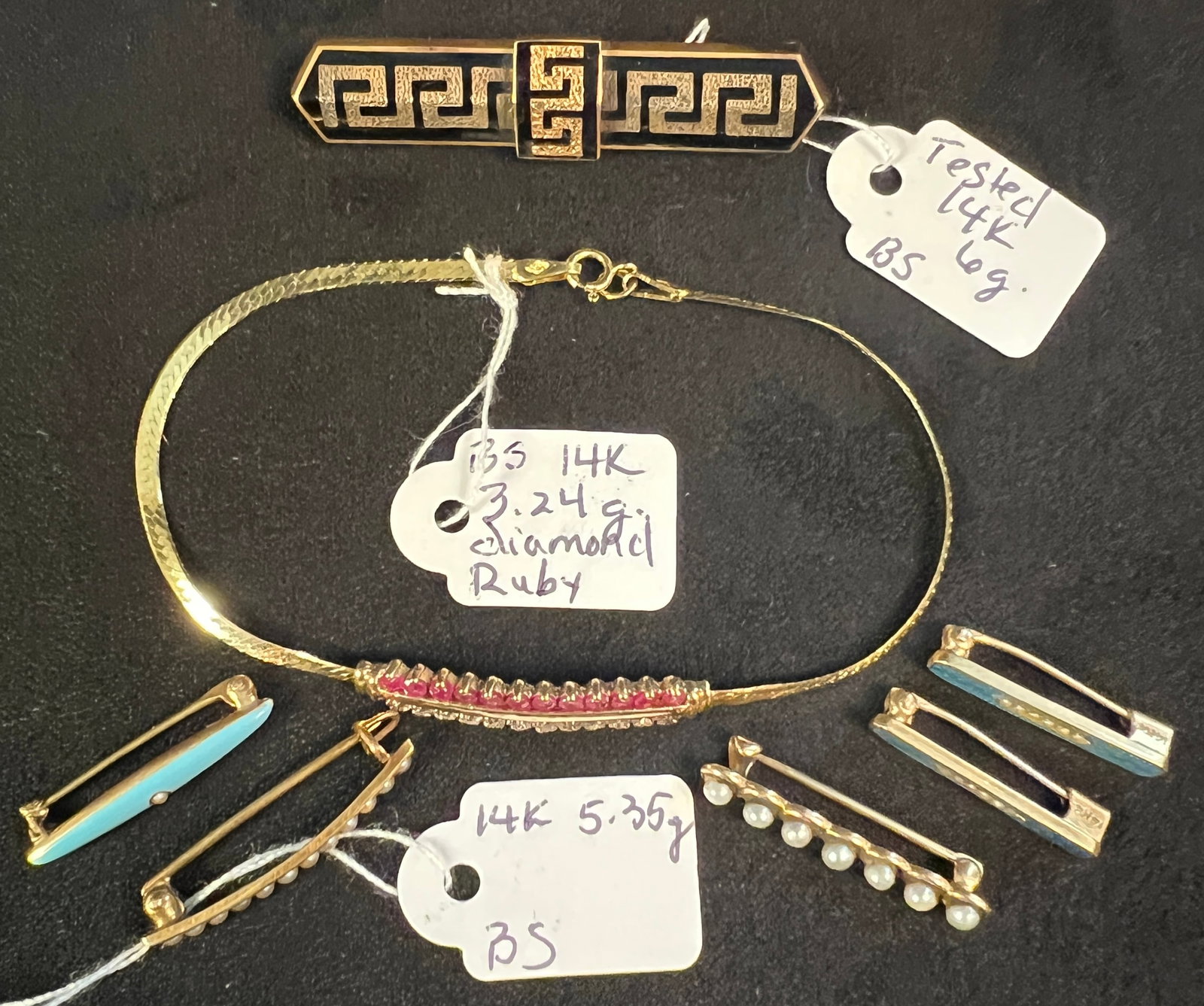 Group of 14K Antique Jewelry: A group of 14K assorted jewelry to include a Victorian Greek key enameled bar pin (6 grams), a 14K diamond and ruby ladies bracelet (3.24 grams), and a group of 5 antique small bar pins (5.35 grams). 