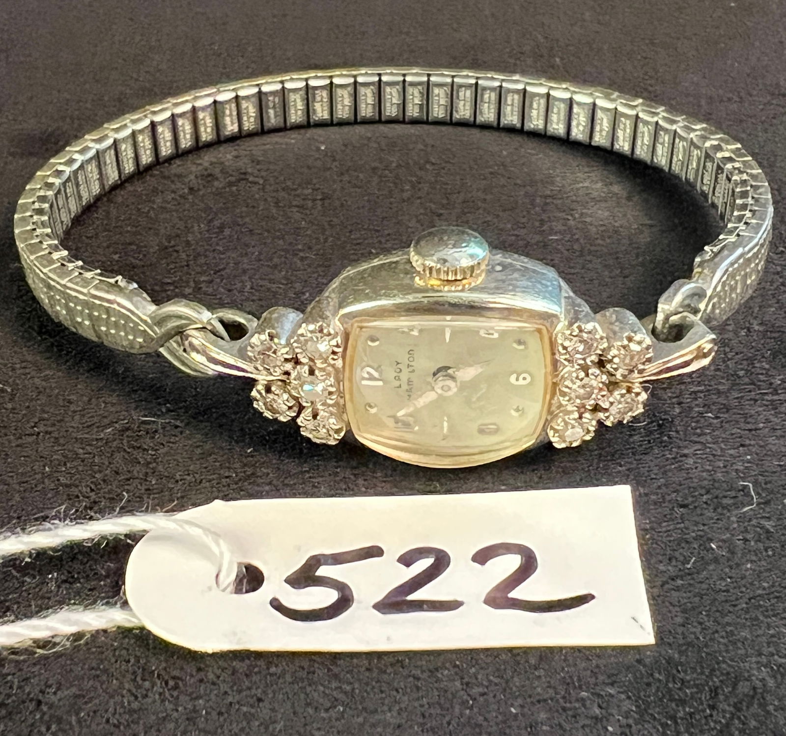 14K and Diamond Lady Hamilton Wristwatch: A 14K and 10 diamond Lady Hamilton wristwatch. Band is stainless steel, but watch case is 14K. In working condition.