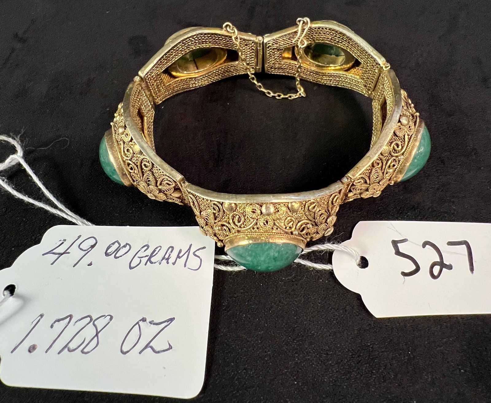 Silver Filagree and Jade Bracelet: Silver filagree and nephrite jade bracelet with safety chain, is marked silver on enclosure. We estimate this piece is 800 silver, it weighs approximately 49.07 grams.