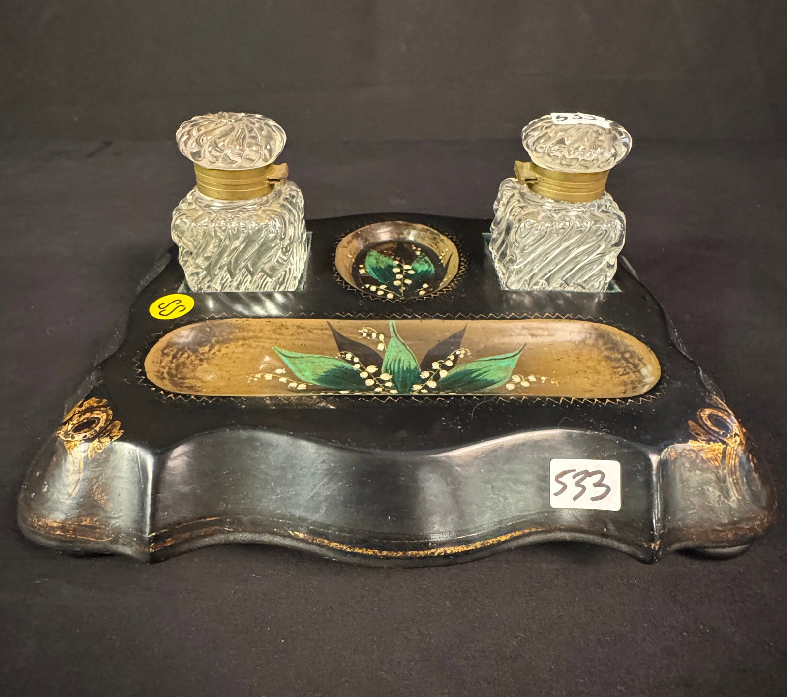 1850s Inkwell Stand with Bottles: An 1850s double inkwell stand with original barley-twist lead crystal ink bottles, that insert into a hand painted and lacquered serpentine stand, on small bun feet. This 1850s inkwell stand has gold 