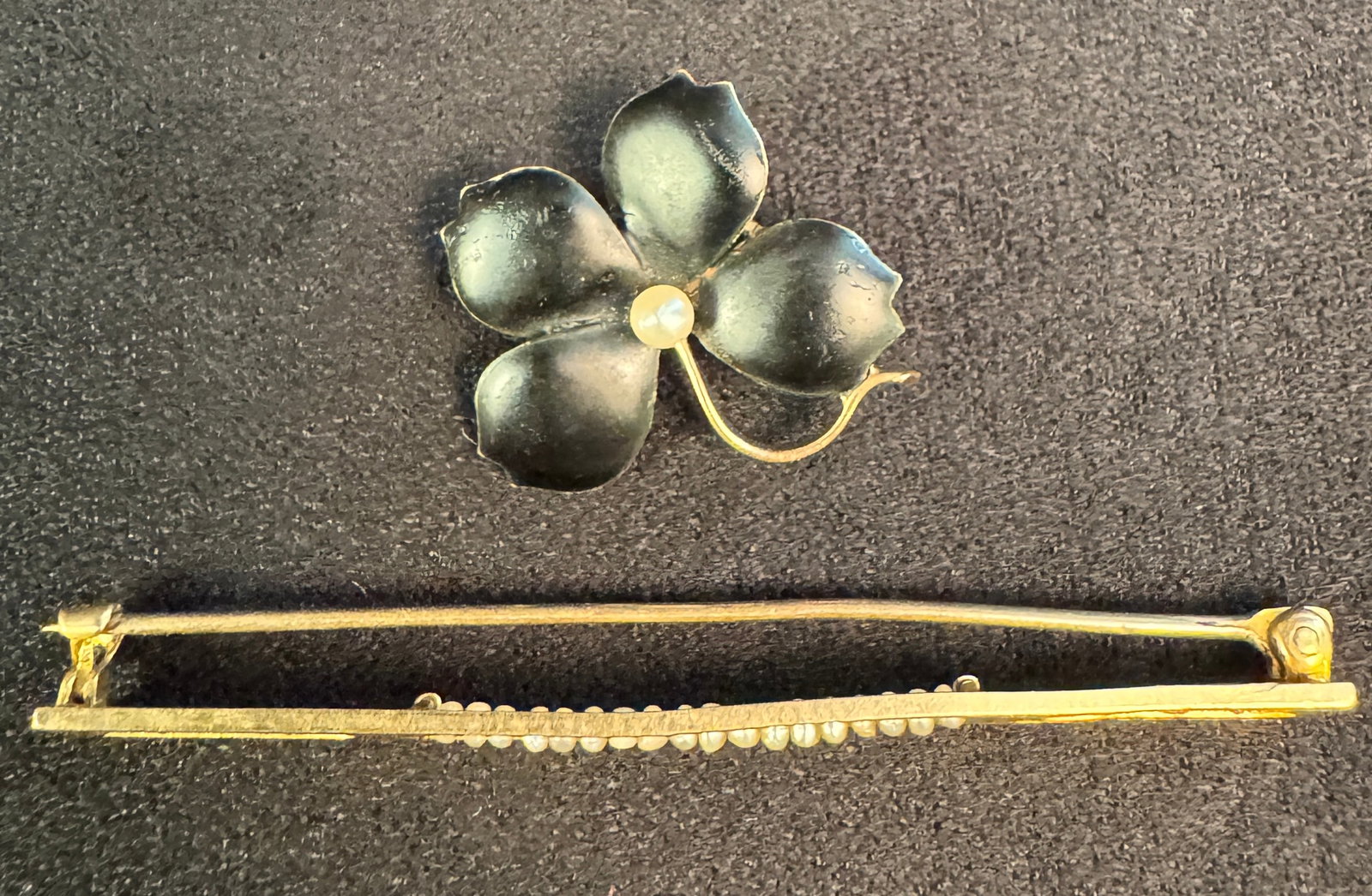 Two 10K Victorian Brooches: Two antique brooches to include a 10K bar pin with seed pearls 2.35 grams and black enamel clover and pearl brooch weighing 1.68 grams. Total is 4.03 grams.