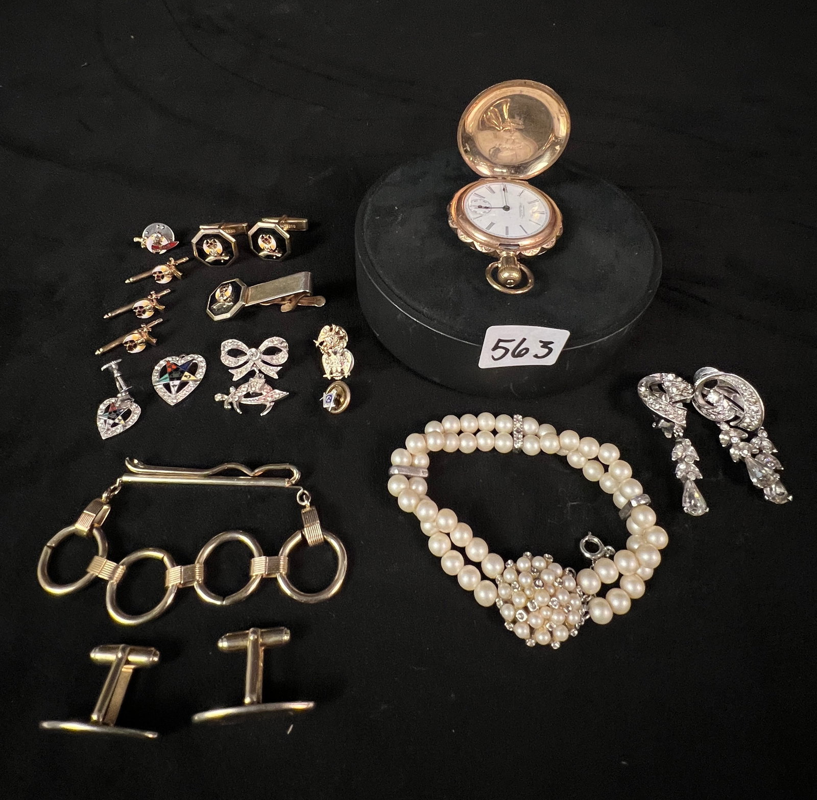 Rolled Gold Pocket Watch, Costume Jewelry and More: A group of jewelry to include a Victorian rolled gold pocket watch (back hinge is broken) by Waltham, faux pearl bracelet with rhinestones, an assortment of Shriner and masonic cufflinks/tietacks, rhi