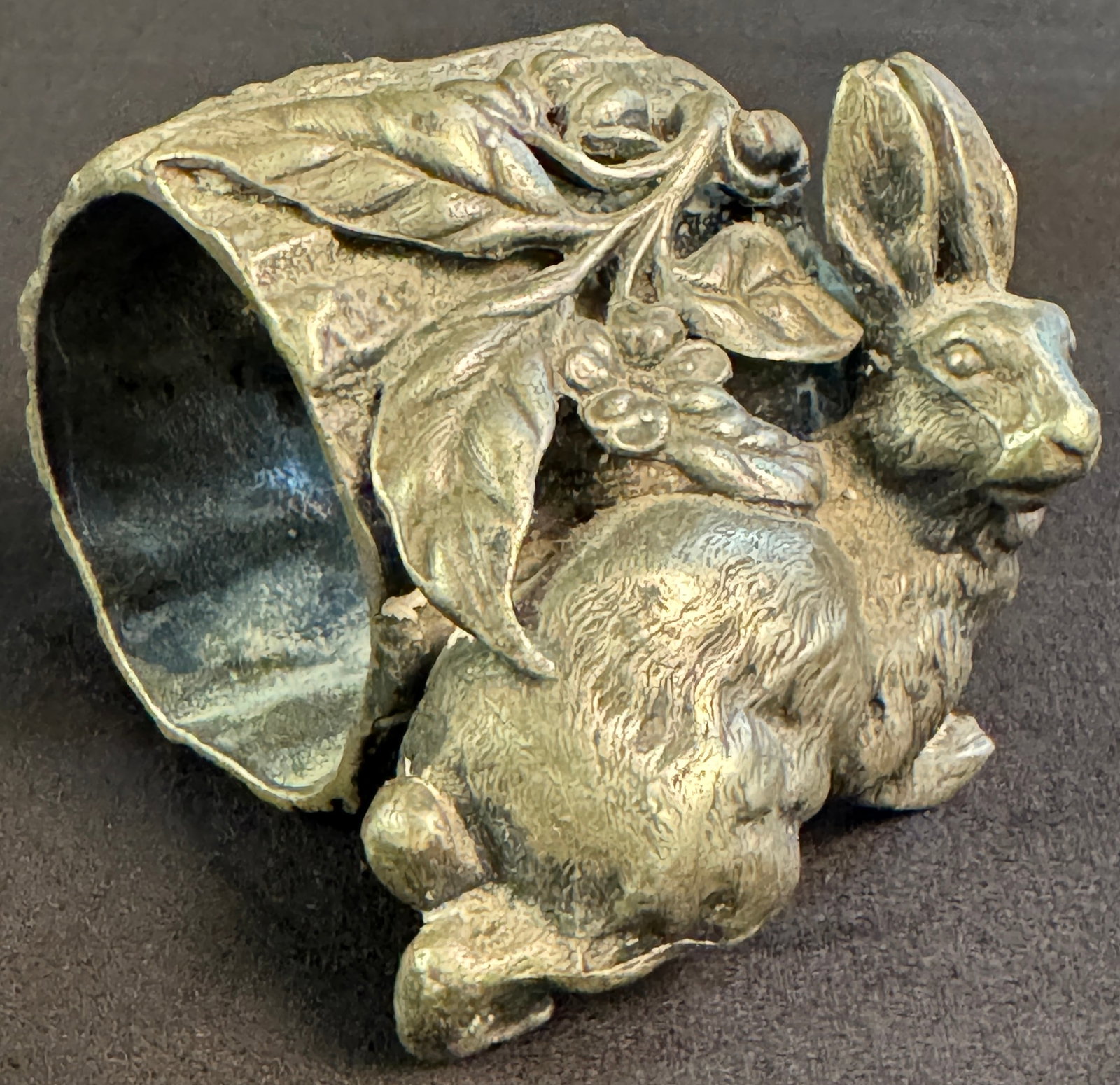 Victorian Figural Rabbit Napkin Holder: A Victorian silverplate figural napkin ring featuring a rabbit surrounded by foliage. Measures 2" tall.
